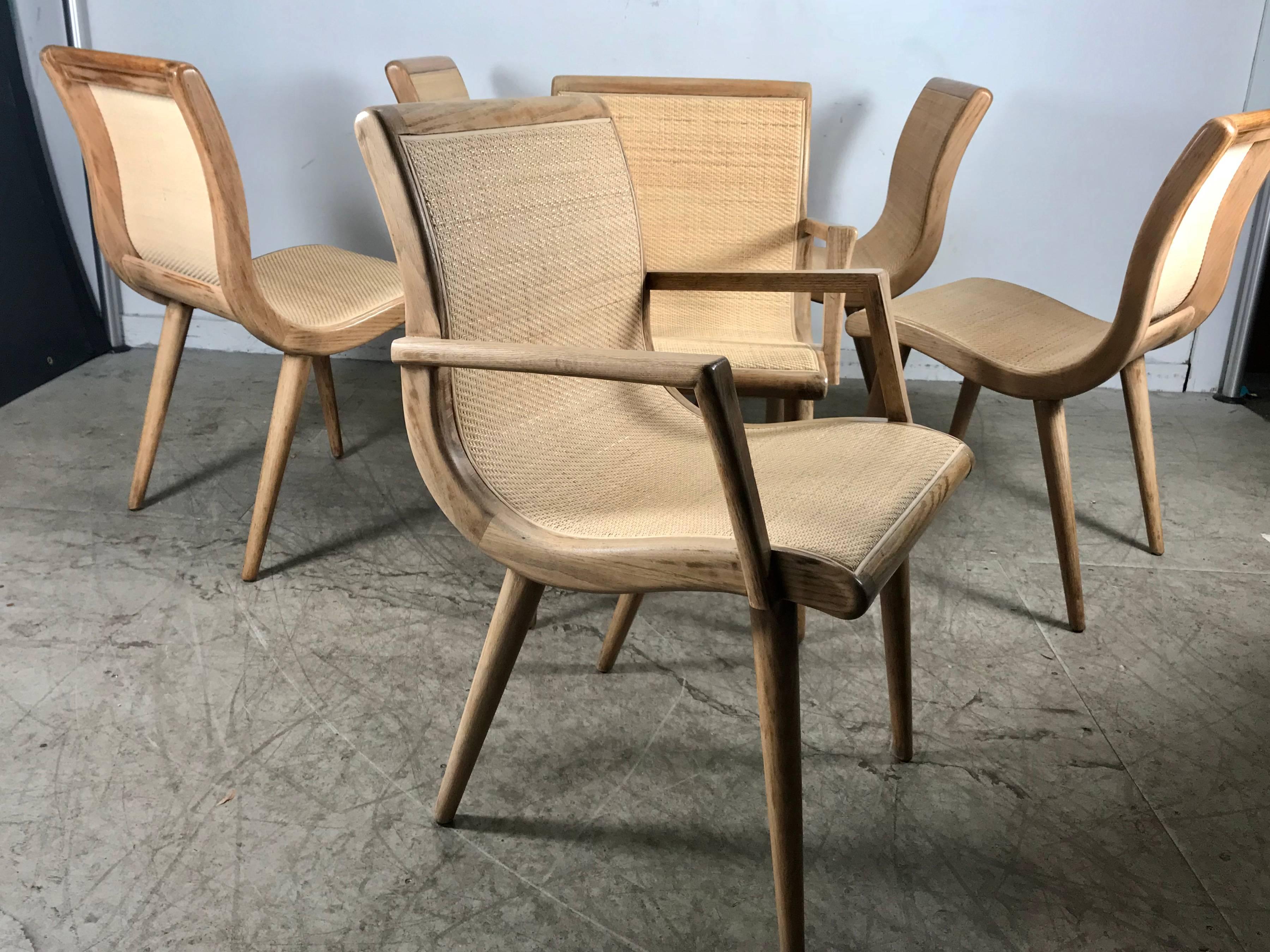 Classic set of six Mid-Century Modern dining chairs designed by Russel Wright for Conant & Ball. Fabric has been removed to expose the graceful wood curved seats, new caning added making this set as fresh today as the day they were designed over 60