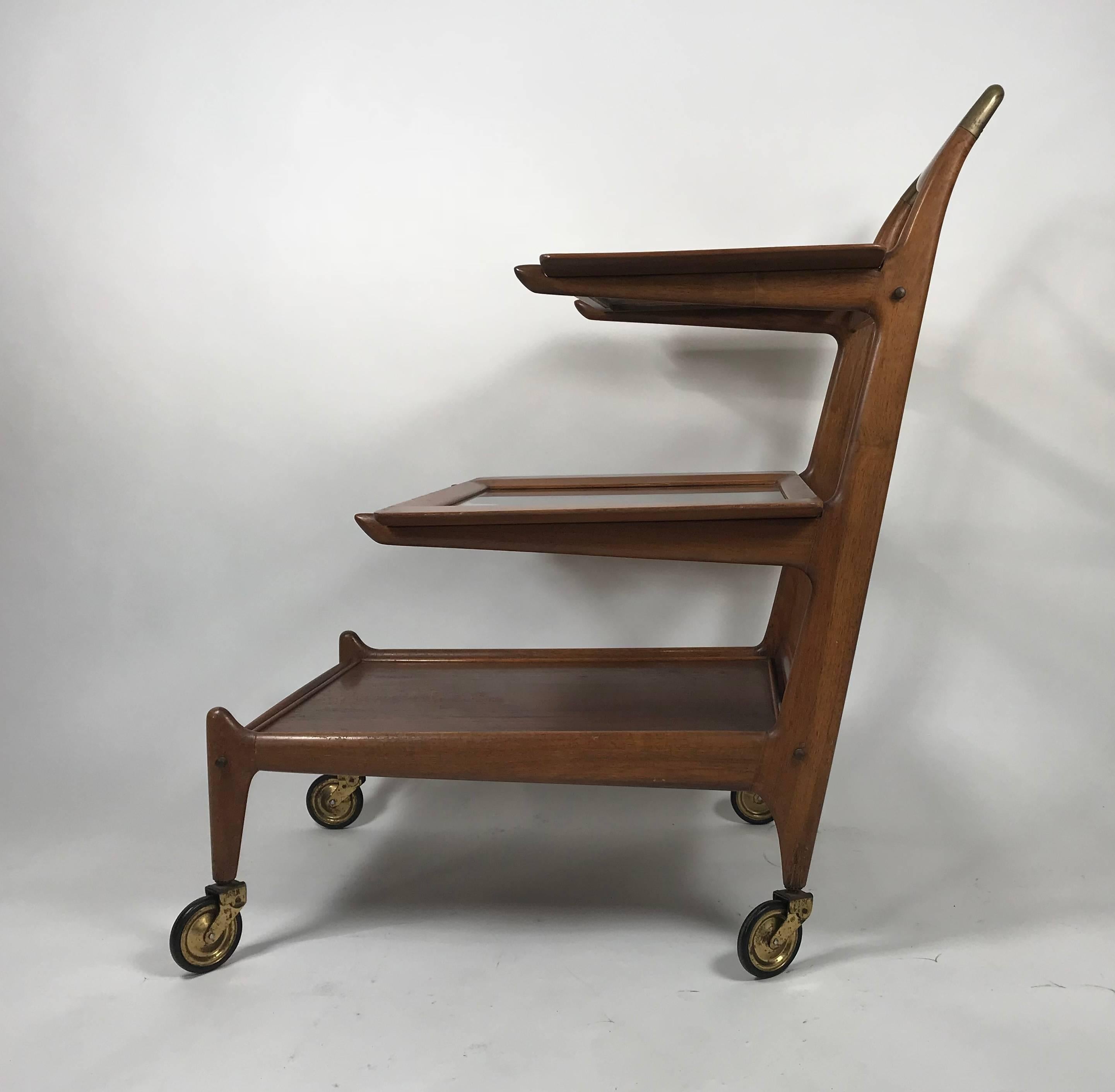 Organic trolley from the 1950s, Italian design by Cesare Lacca, beautiful sculpted walnut. Three removable trays, brass mountings. Made in Italy. Hand delivery avail to New York City or anywhere en route from Buffalo New York.