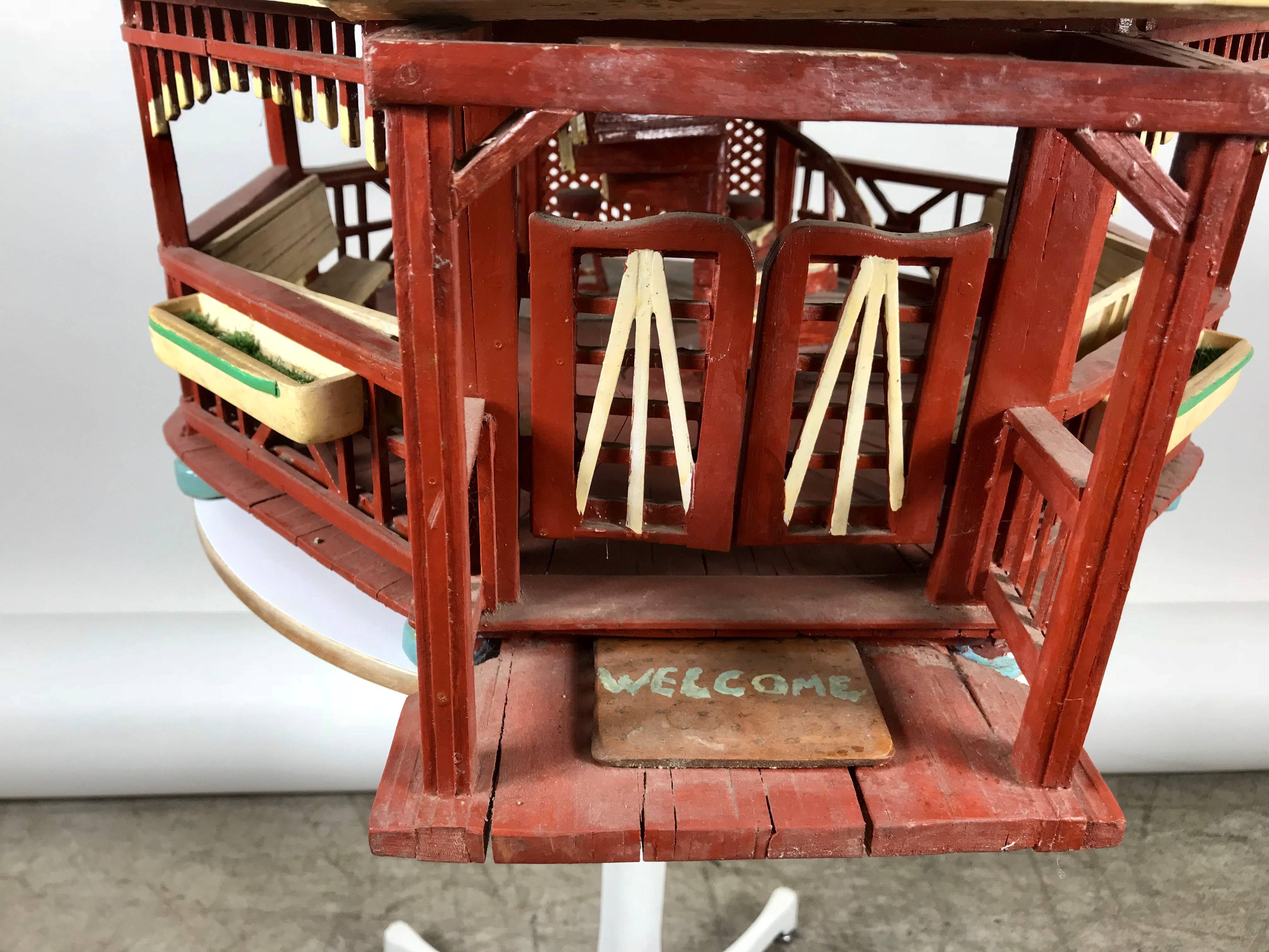 Handmade Folk Art Gazibo / house. All wood construction,, features spiral staircase, benches and stools on the interior, slat wood roof, railing detail. Swinging doors, screened windows, planter boxes, charming design.