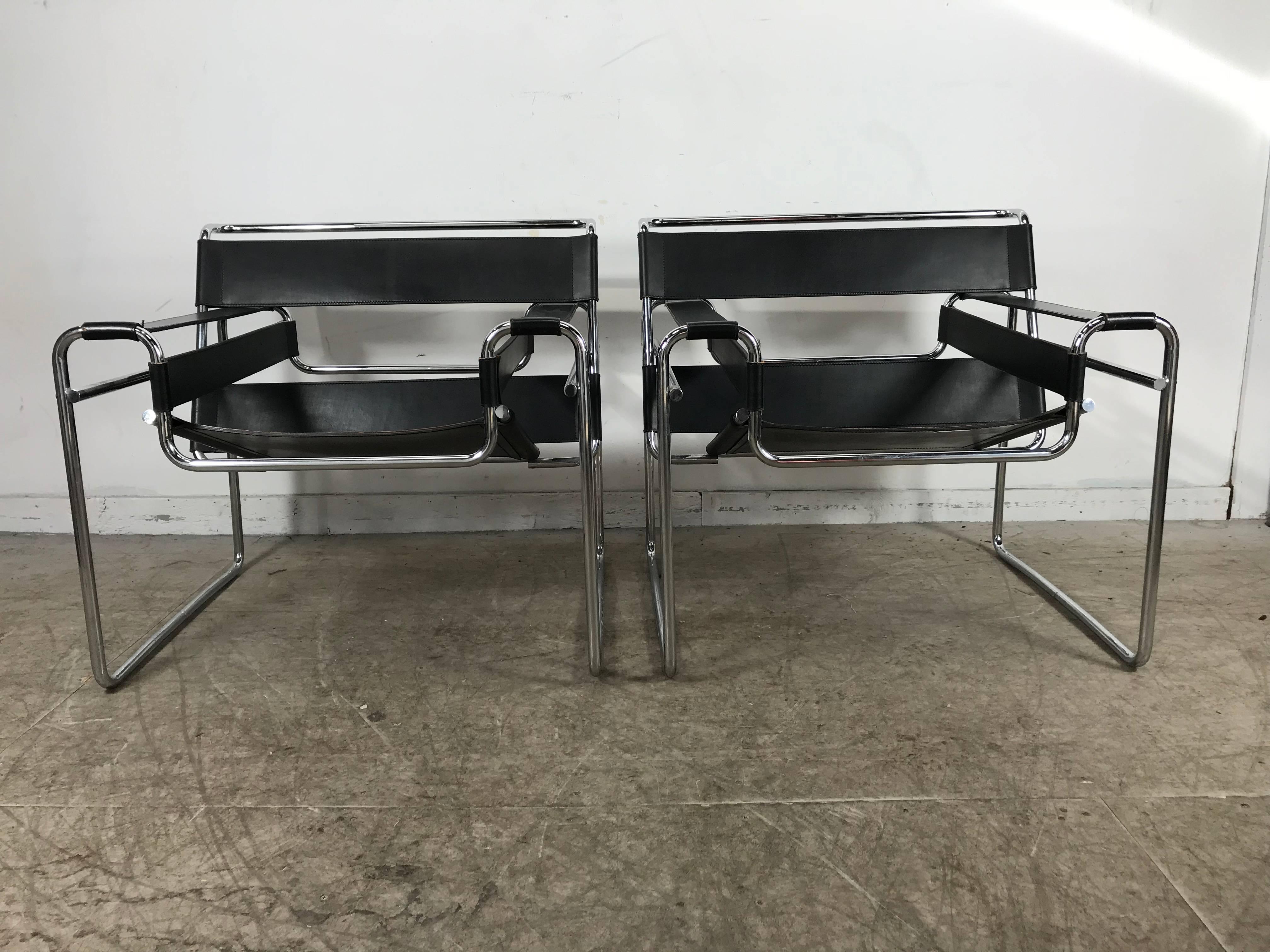 Pair of Classic Bauhaus black leather and chrome Wassily chairs designed by Marcel Breuer manufactured by Knoll, beautiful original condition, retain early Knoll International label. Hand delivery avail to New York City or anywhere en route from
