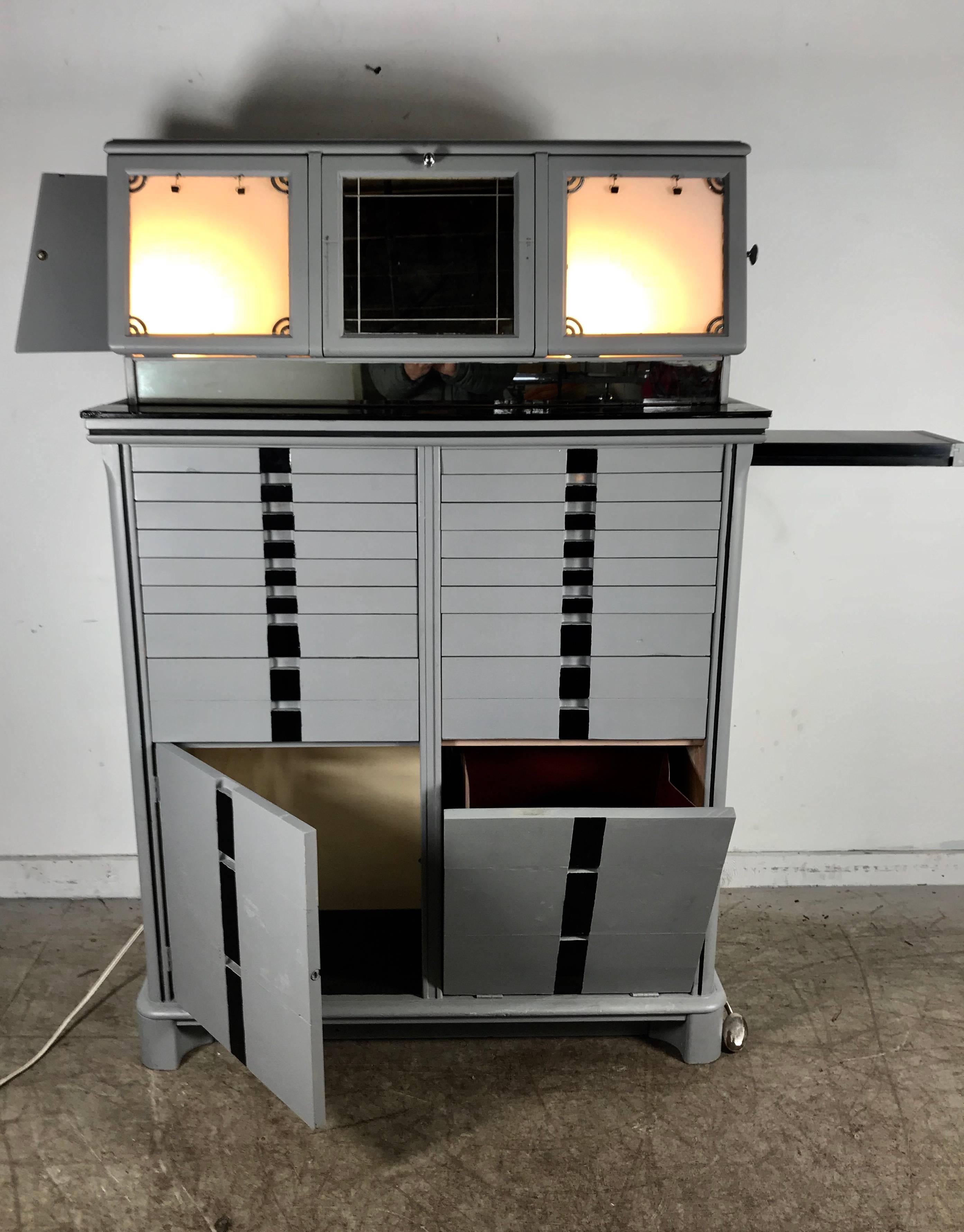 Rare Art Deco Illuminated Multi drawer Dental Cabinet  by the Weber Dental manufacturing company .Amazing cabinet featuring original frosted glass back-lit panels with original clips for holding x-rays, Mirrored pull down door with milk glass shelf,
