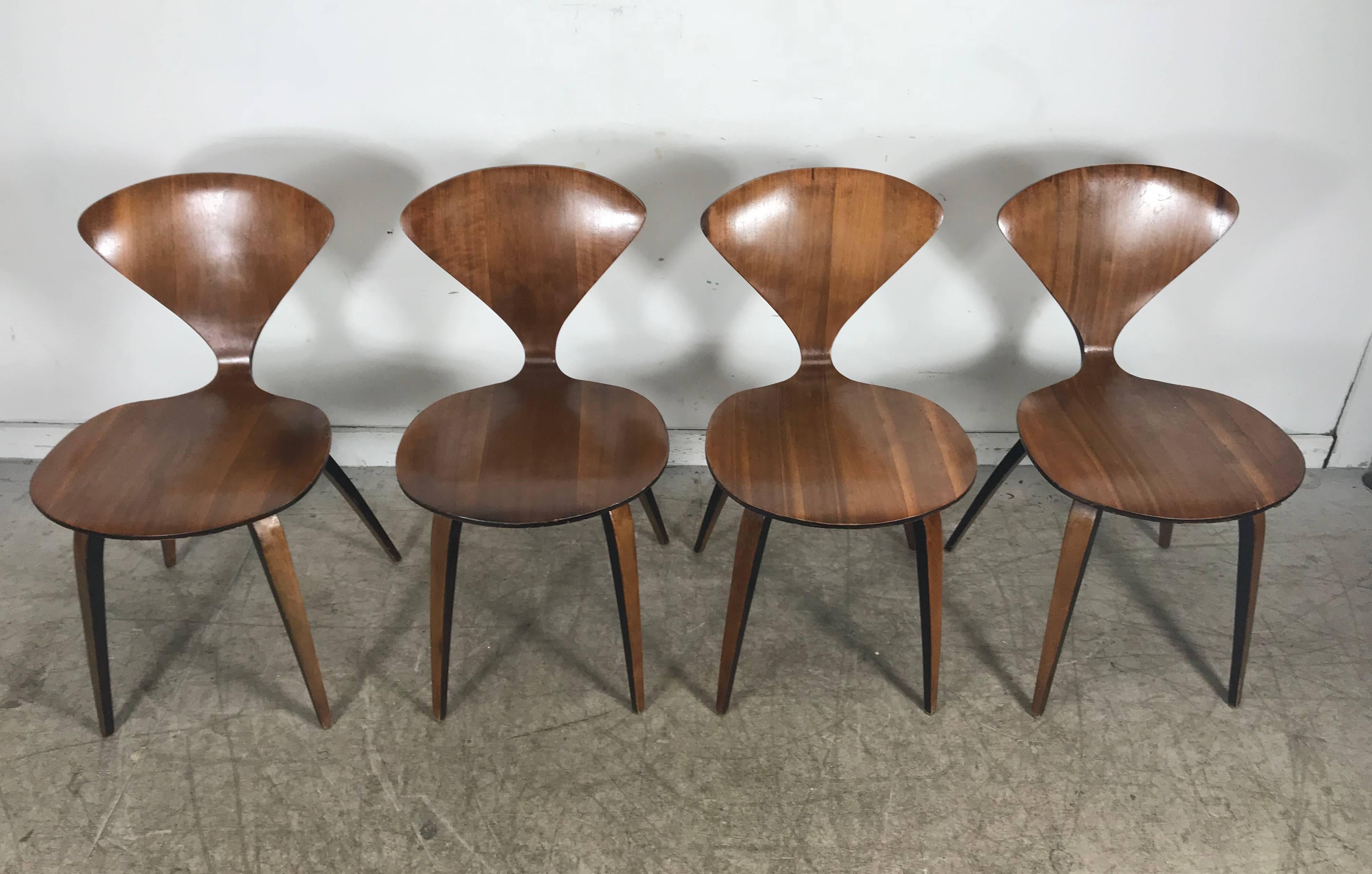 Classic Mid-Century Modern molded and bent plywood side chairs by Norman Cherner for Plycraft, retain early Plycraft label. Original finish, age appropriate wear. Minor veneer chip to one chair, see photo. Extremely comfortable, structurally sound.