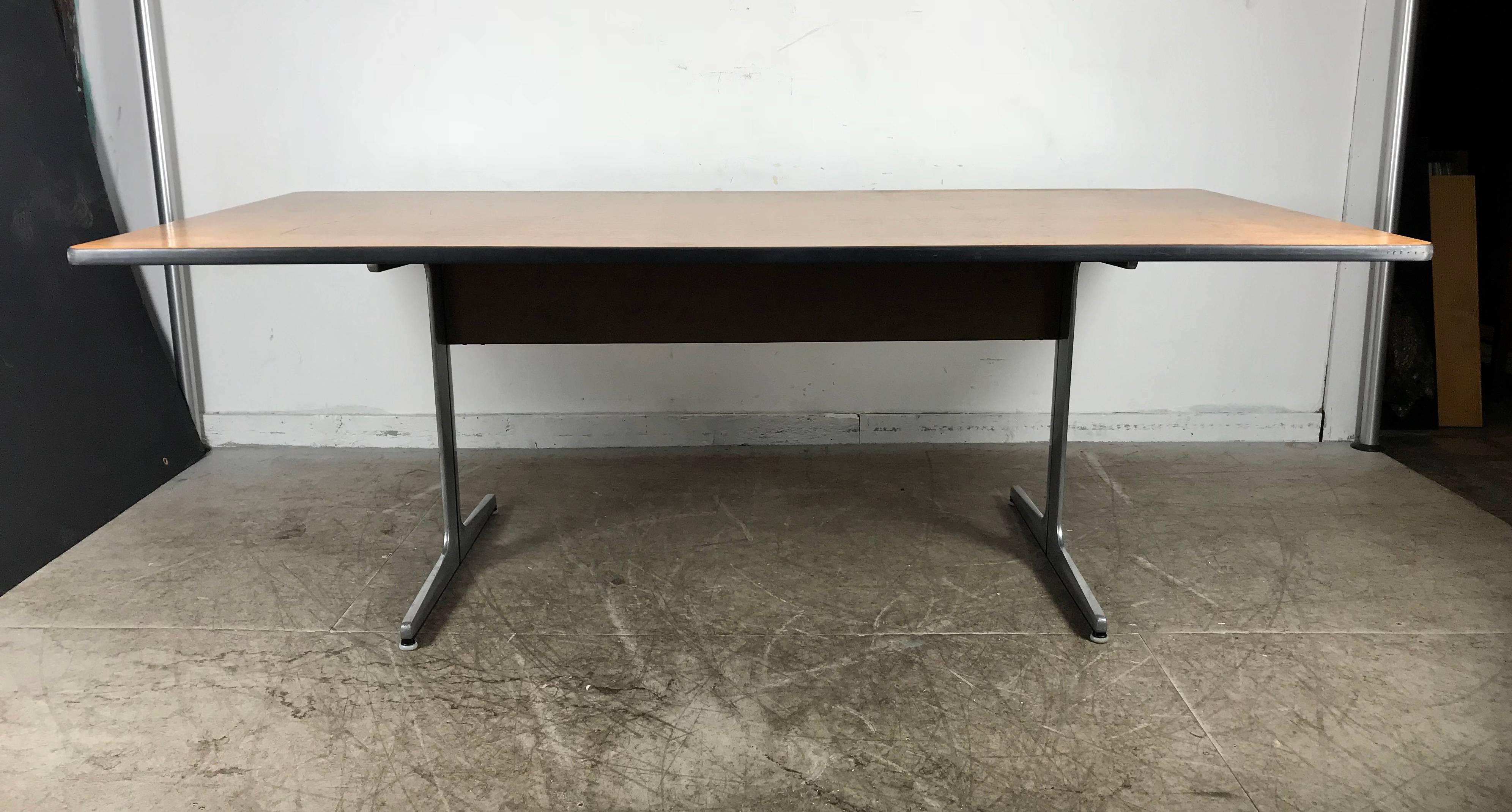 Rarely seen modernist action office desk or conference table by George Nelson for Herman Miller. Purchased from prominent Buffalo NY architect. Beautiful figured walnut wood top minor scratches. Original cast aluminum base. Hand delivery avail to