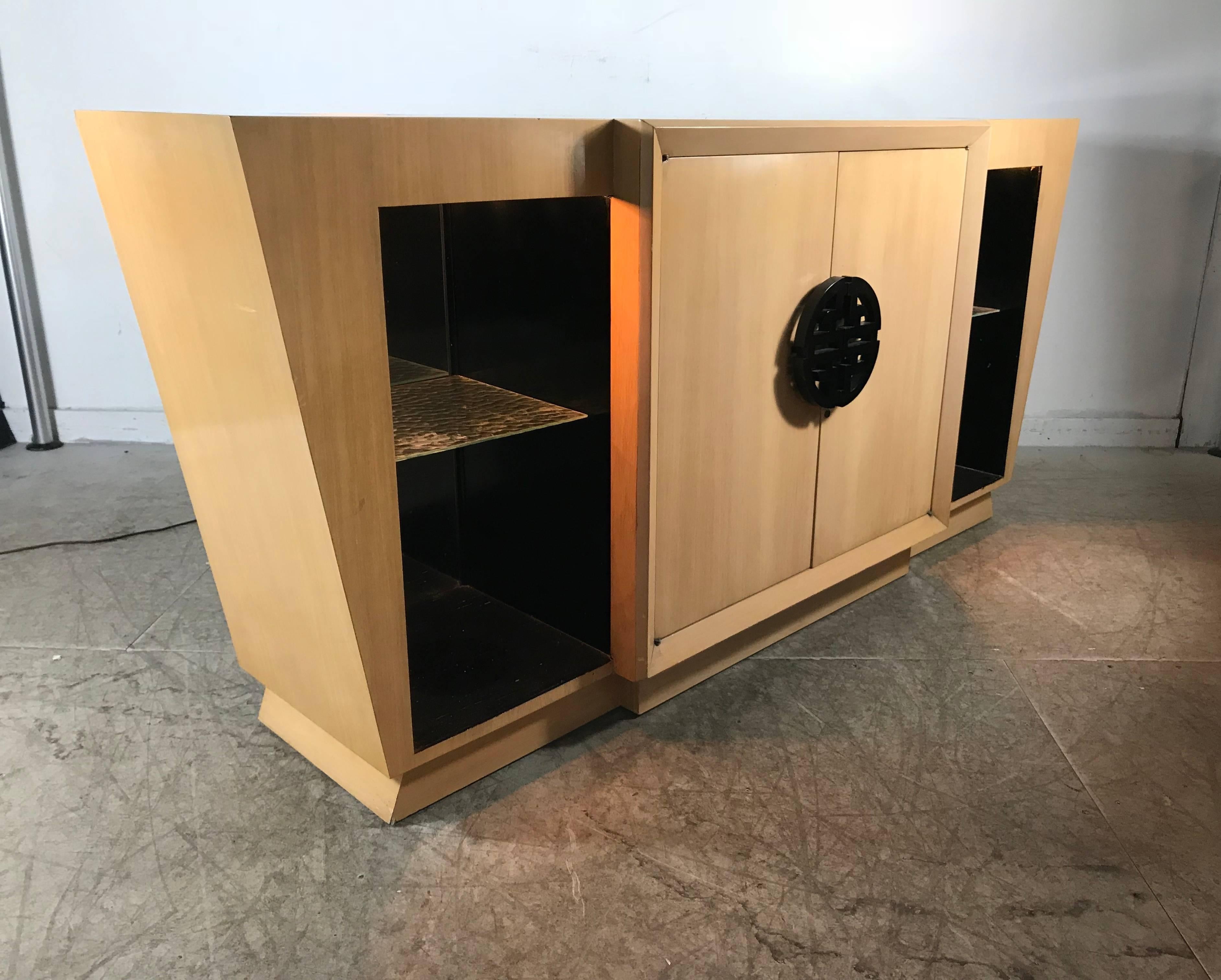 Asian Modern, Art Deco style light up dry bar or sideboard by Karpin, Maximillion Design, wonderful bleached mahogany and black lacquer. Left and right cubbies with lights which illuminate through top. Chinese black lacquer hand pull. Center doors