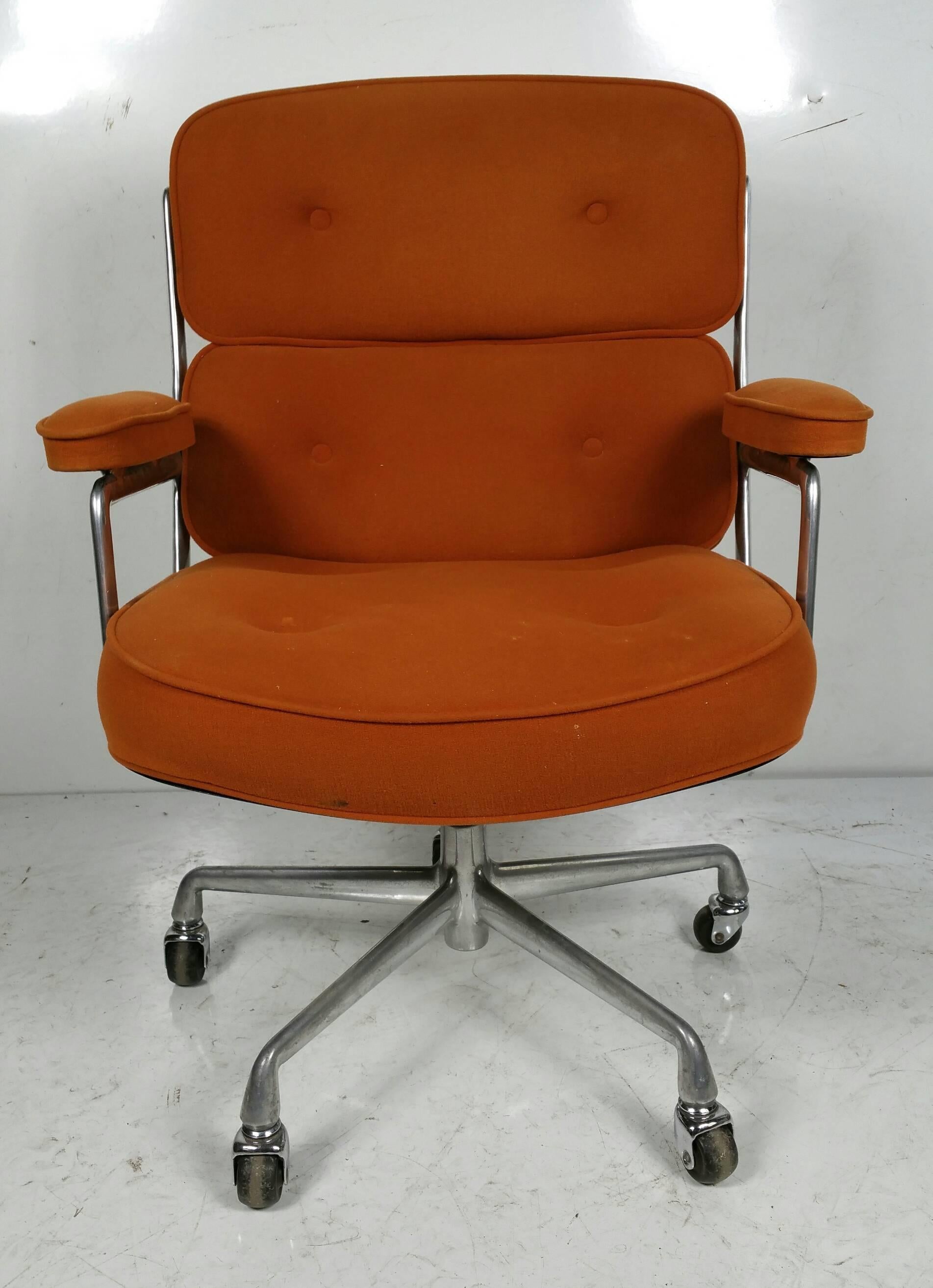 Charles and Ray Eames Time Life Chair,, Original tangerine cotton felt fabric,,  5 star base with castors,, Tilt,swivel mechanism,,adjustable height,,Cast aluminum frame.