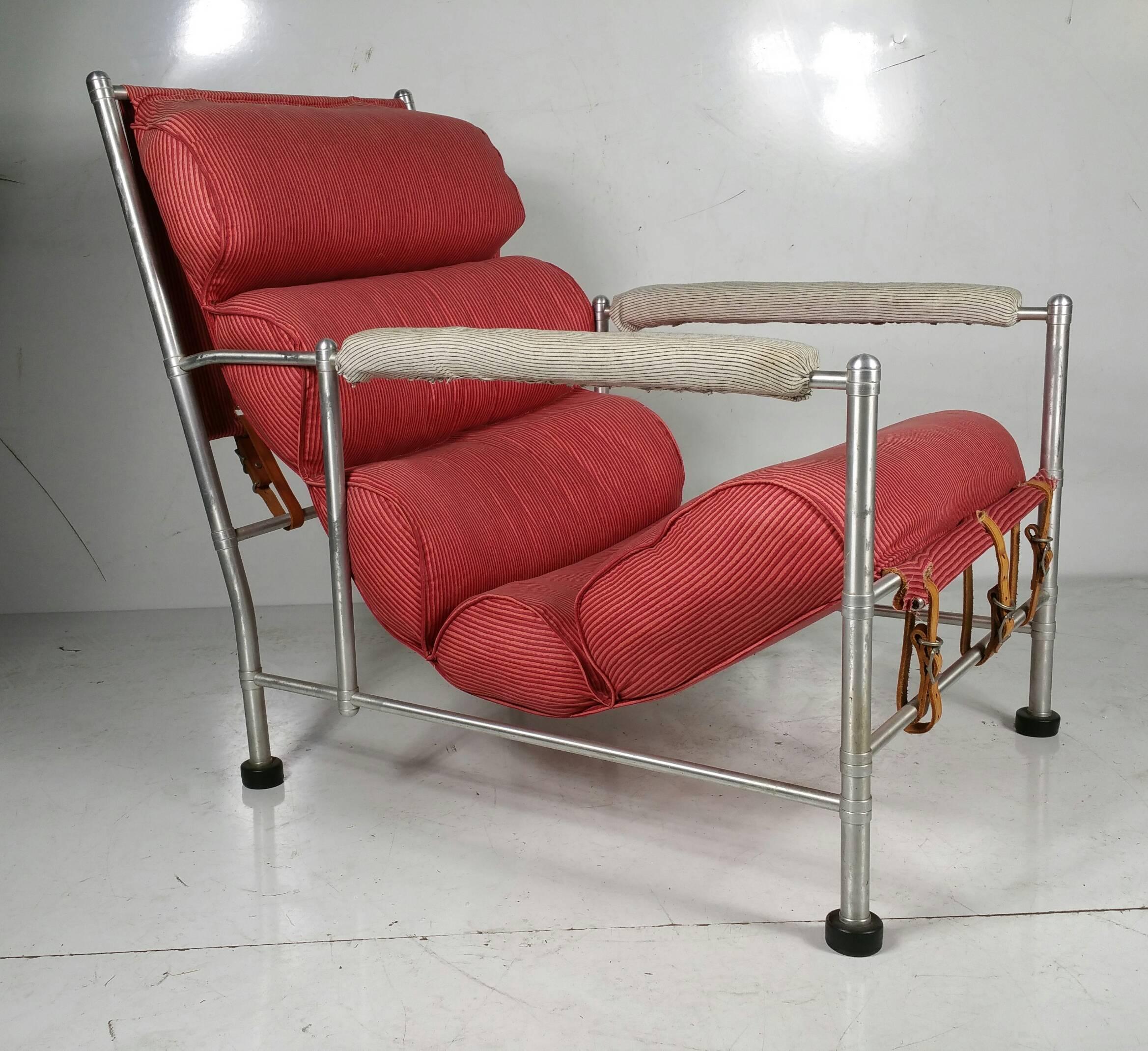 Streamlined Art Deco Lounge Chair, designed by Warren McArthur, circa 1930's. Retains warm original patina to aluminum. Currently upholstered in a cotton fabric.. 