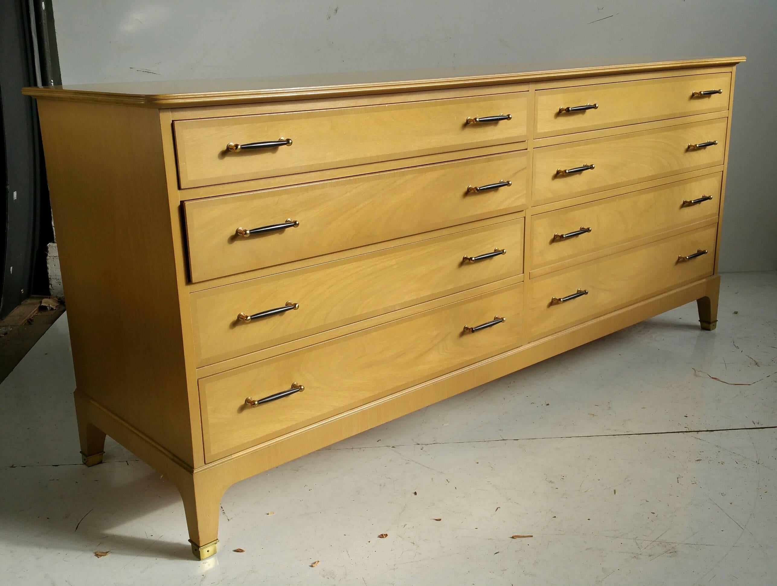 Simple, elegant dresser designed by Renzo Rutili for Johnson Furniture Company, Classic modernist, warm blonde mahogany, wonderful brass detailing to feet. Brass and lacquer pulls.