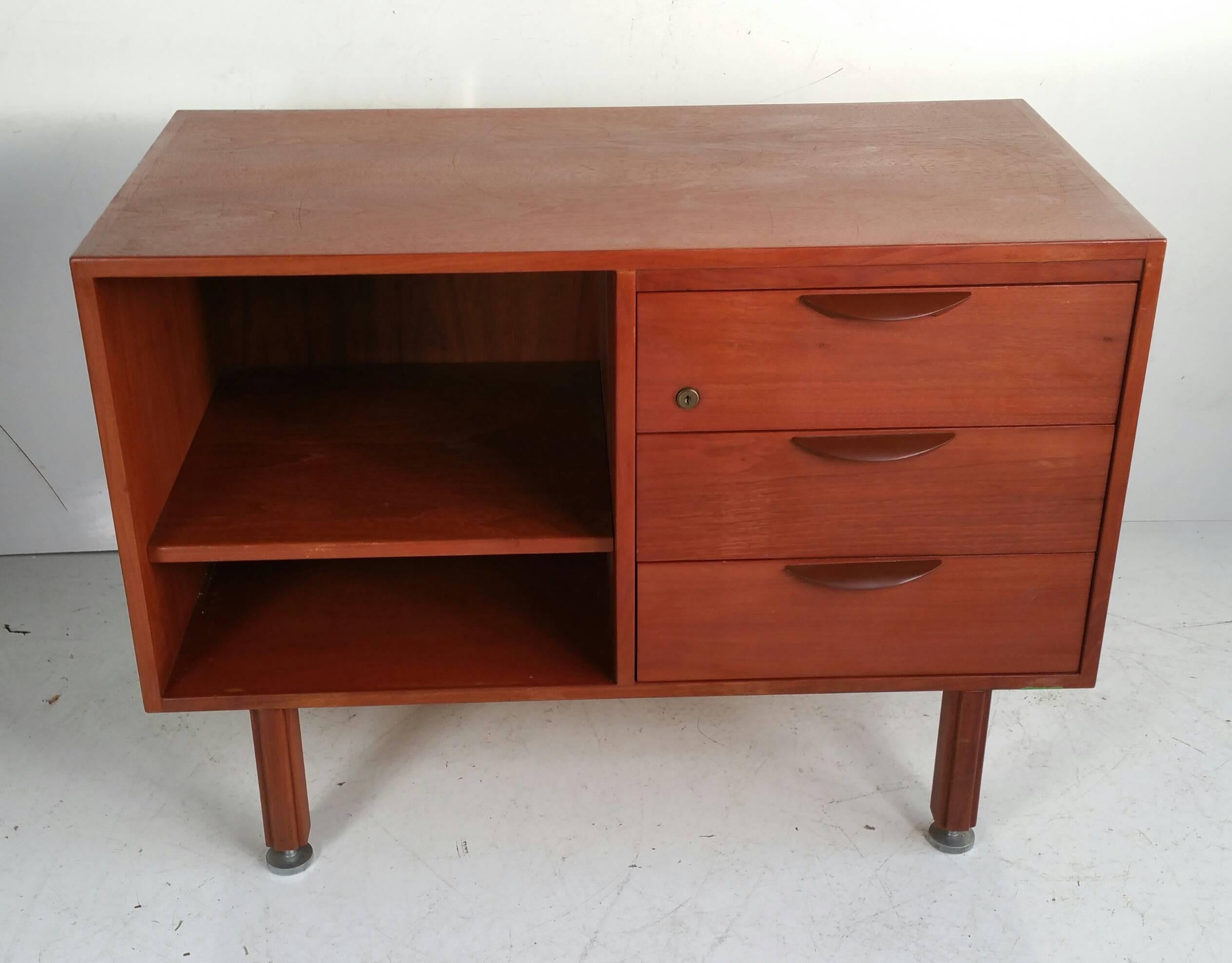 Jens Risom Walnut Credenza featuring 3 drawer (R) and adjustable shelf,(L),Sleek simple design,Great size..proportion.Retain original stainless steel foot glides.;levelers.Lacquered metal hand pulls.Jens Risom Design Label.