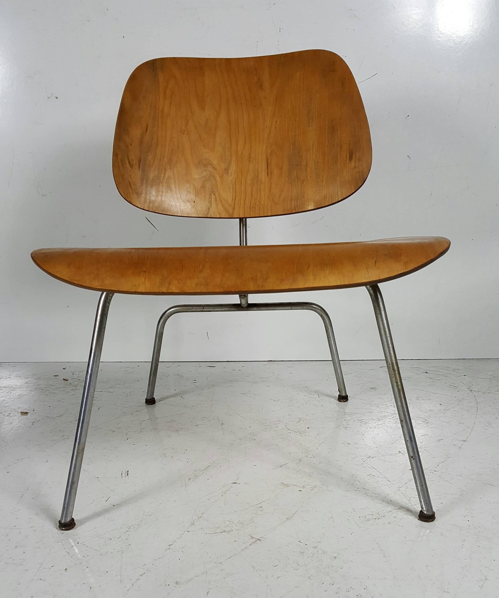 Nice early example,, Classic lounge chair designed by Charles and Ray Eames..  manufactured by Herman Miller,, Retains early foot glides,,