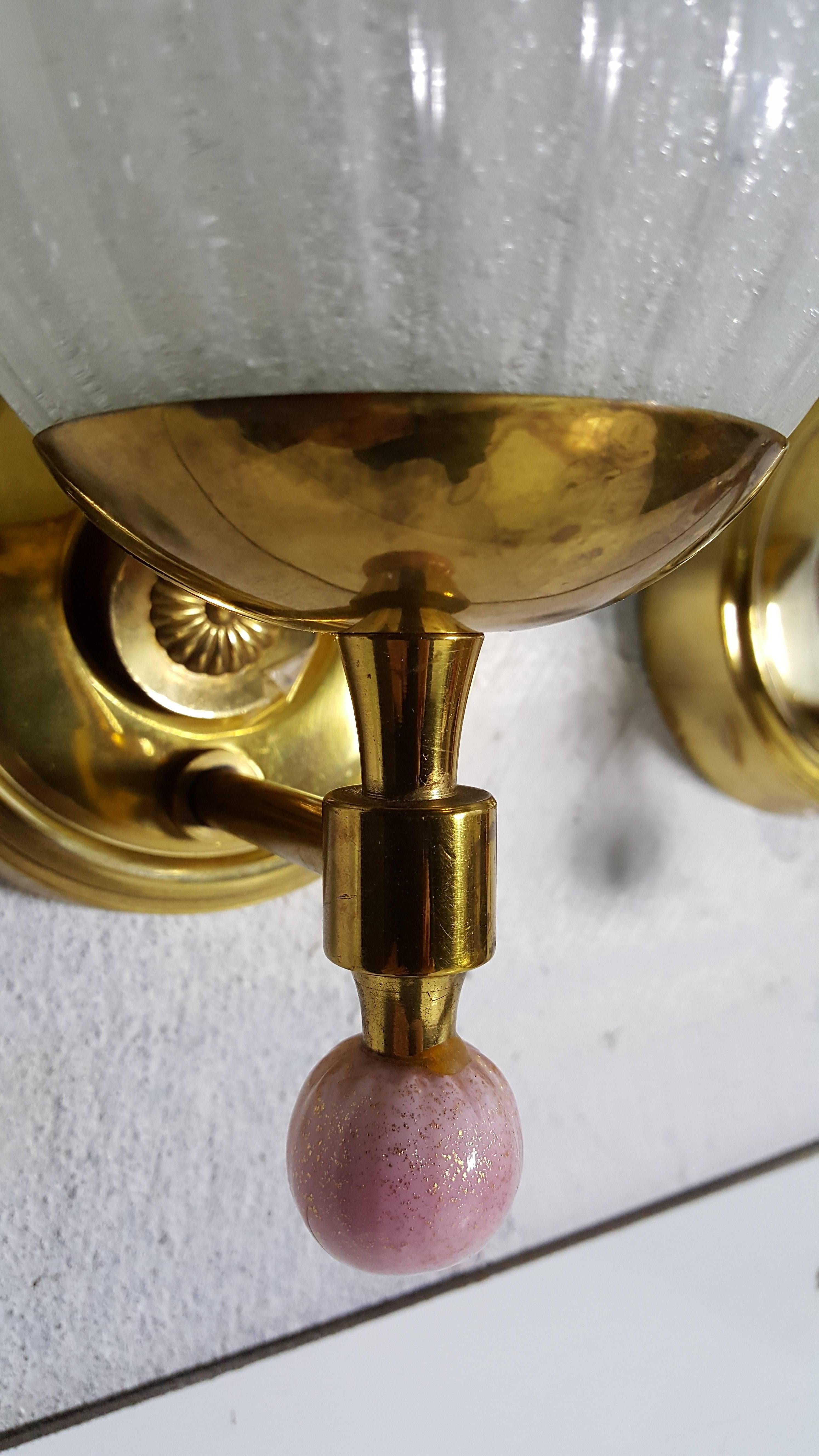 Amazing pair of brass and Murano glass sconces. Brass fixtures made by Lightolier. Blown glass shades and ball finial made by Barovier & Toso. Stunning.