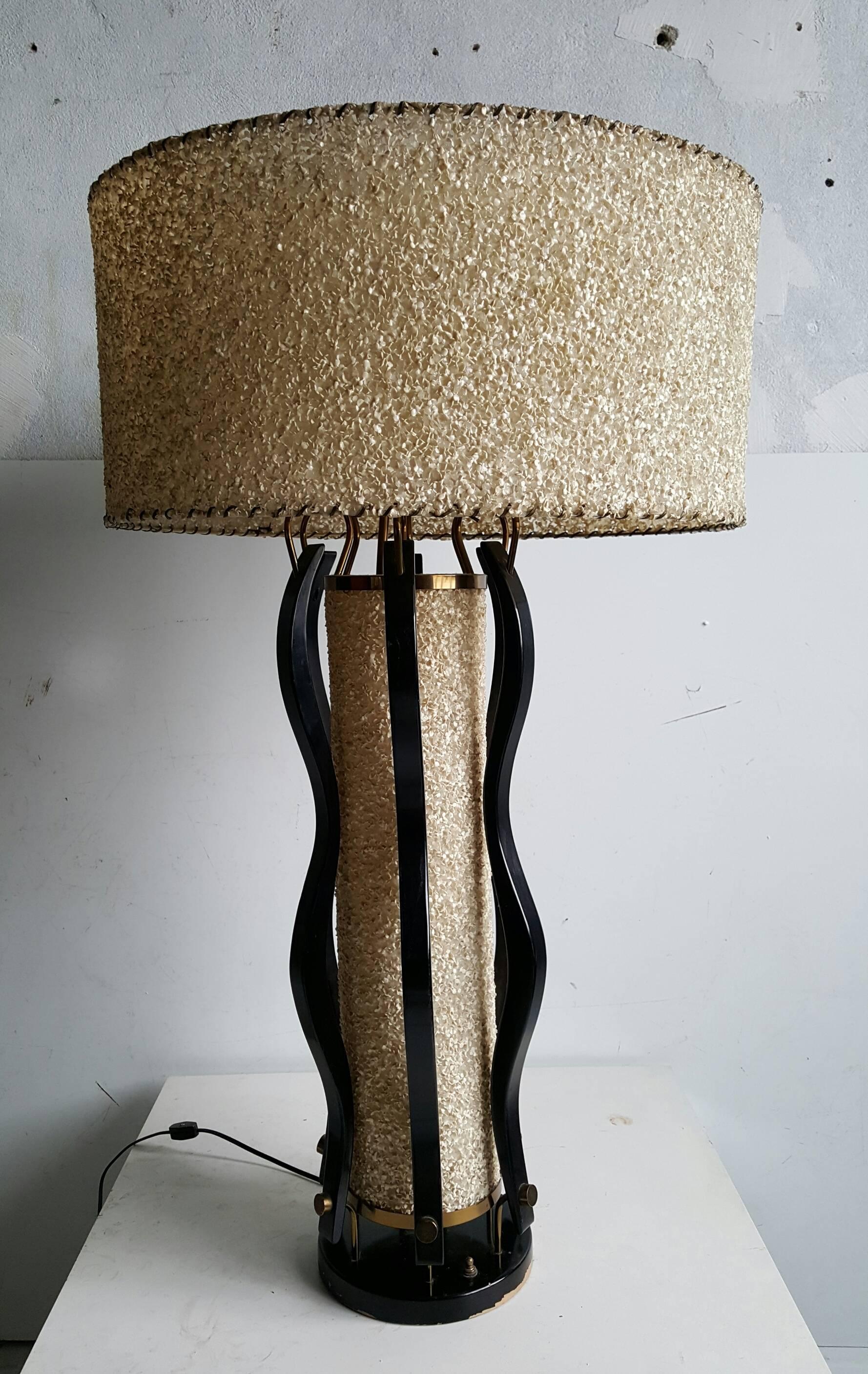 Unusual and rare modern Majestic table lamp..Wonderful curved sculpted wood body,brass detailing and original pebbled parchment shades,,Two light options,,center and top can be luminated seperatly..Top shade measures 22
