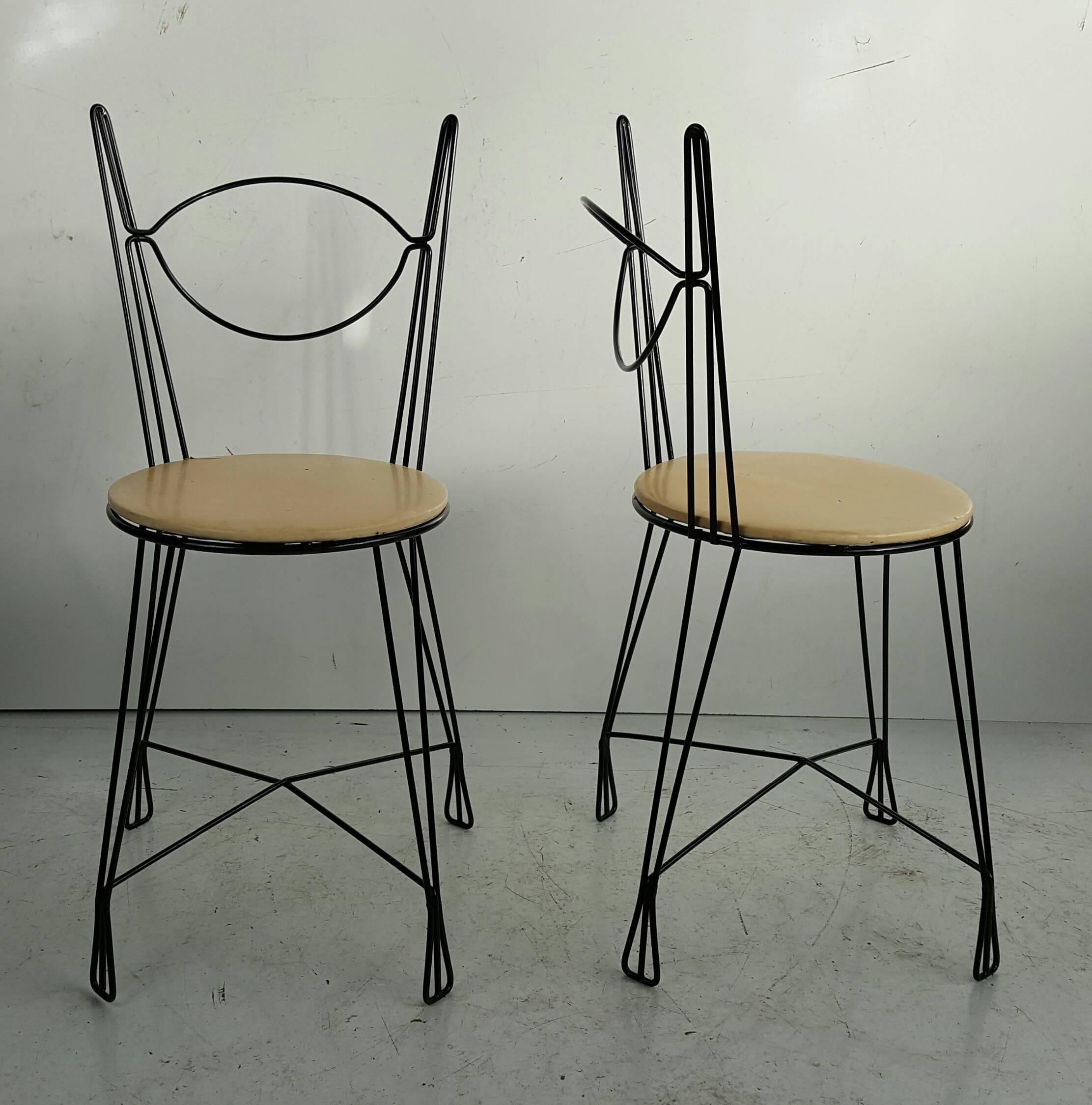 Nice pair of Tony Paul for Raymor twisted iron black metal chairs. Open metal framework, with four leg cross support. Round seat covered in original cream color vinyl.