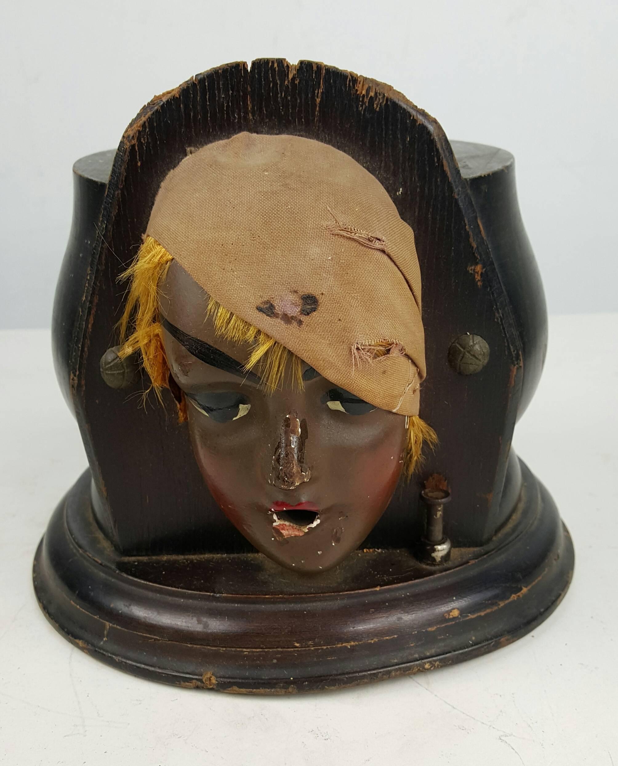 Cigarette dispenser, Flapper Lady, Turban Flapper cigarette dispenser, American, circa 1920s. Carved wood with composition and cloth depiction of 