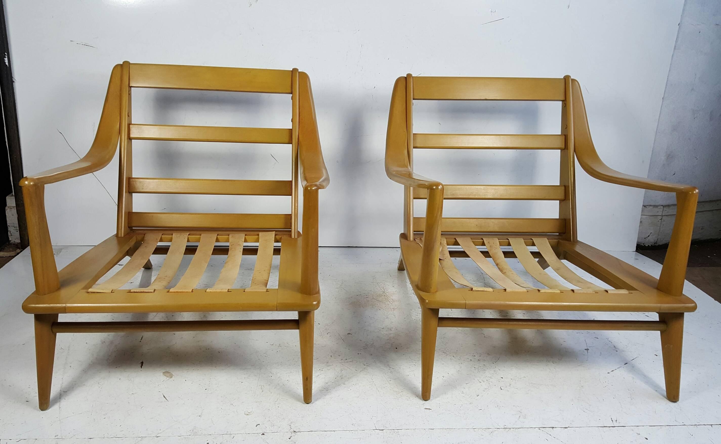 Classic Mid-Century Modern streamline lounge chairs manufactured by Heywood-Wakefield. Solid birch wood construction. Wheat finish.