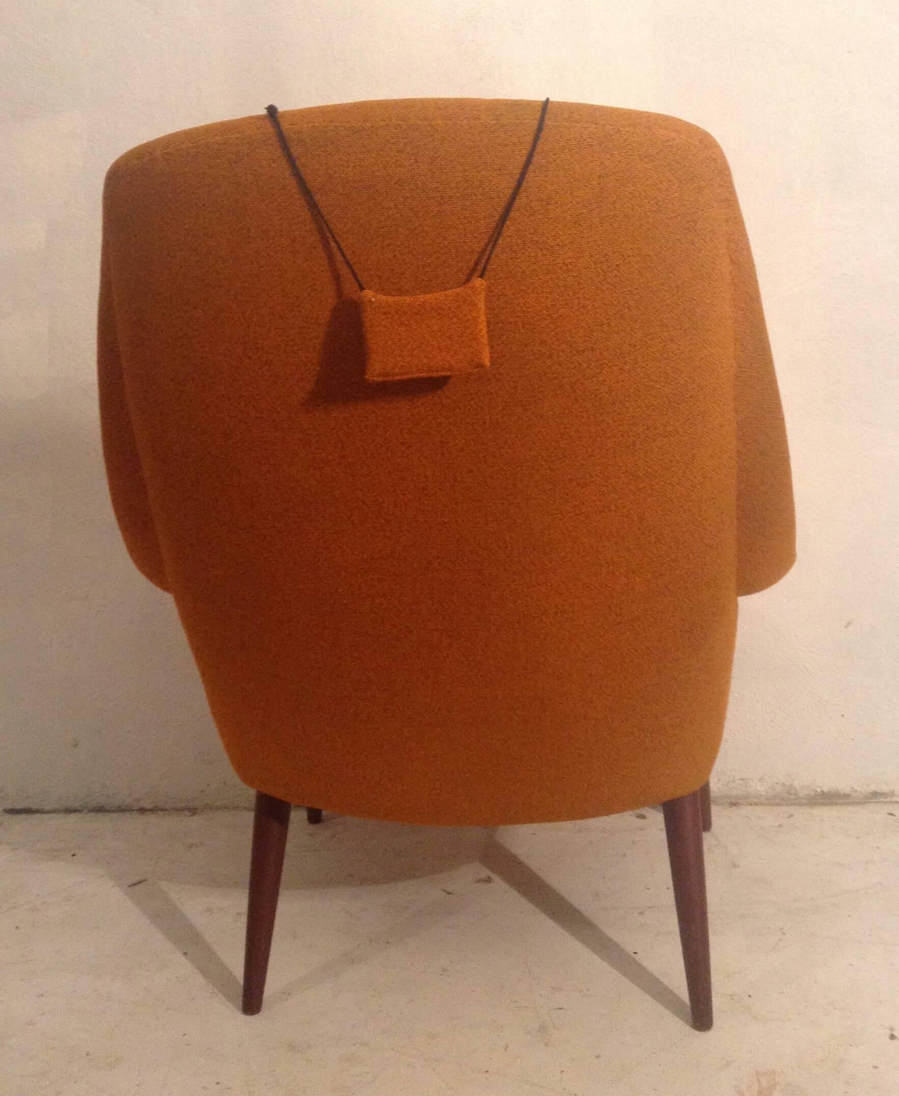 A rare chair, by uncommon maker. Beautiful Mid-Century Scandinavian form designed by Gerhard Berg, made in Sykkylven Norway. Over all, nice original condition, retains original tangerine orange wool fabric, teak arms and conical legs, extremely