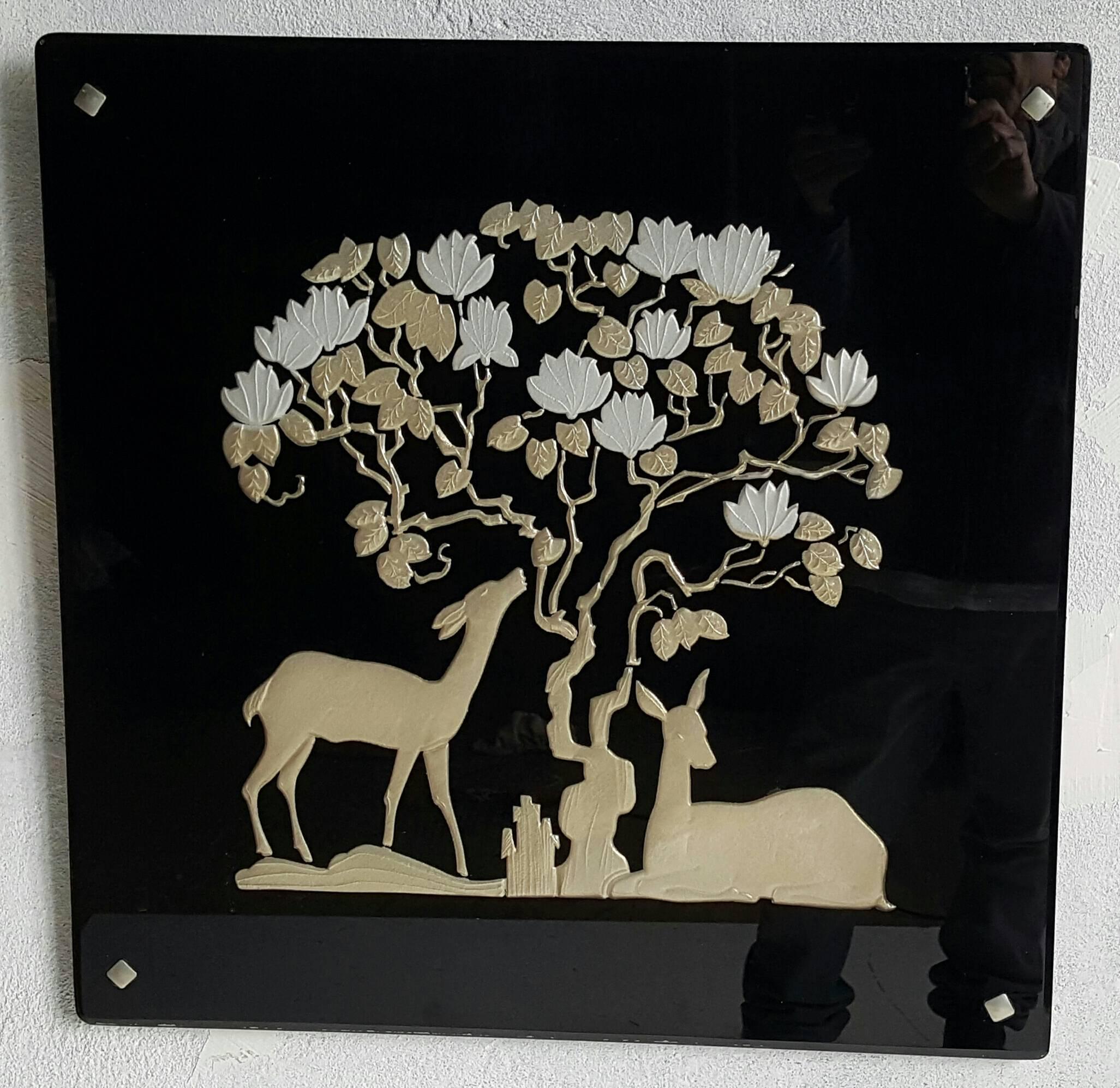 Seldom seen Art Deco black glass mirror (vitrolite), circa 1930s, beautifully reversed decorated with wonderful flowering tree and deer motif. Retain original nickeled square grommets, remarkable original condition, free of scratches, chips etc.