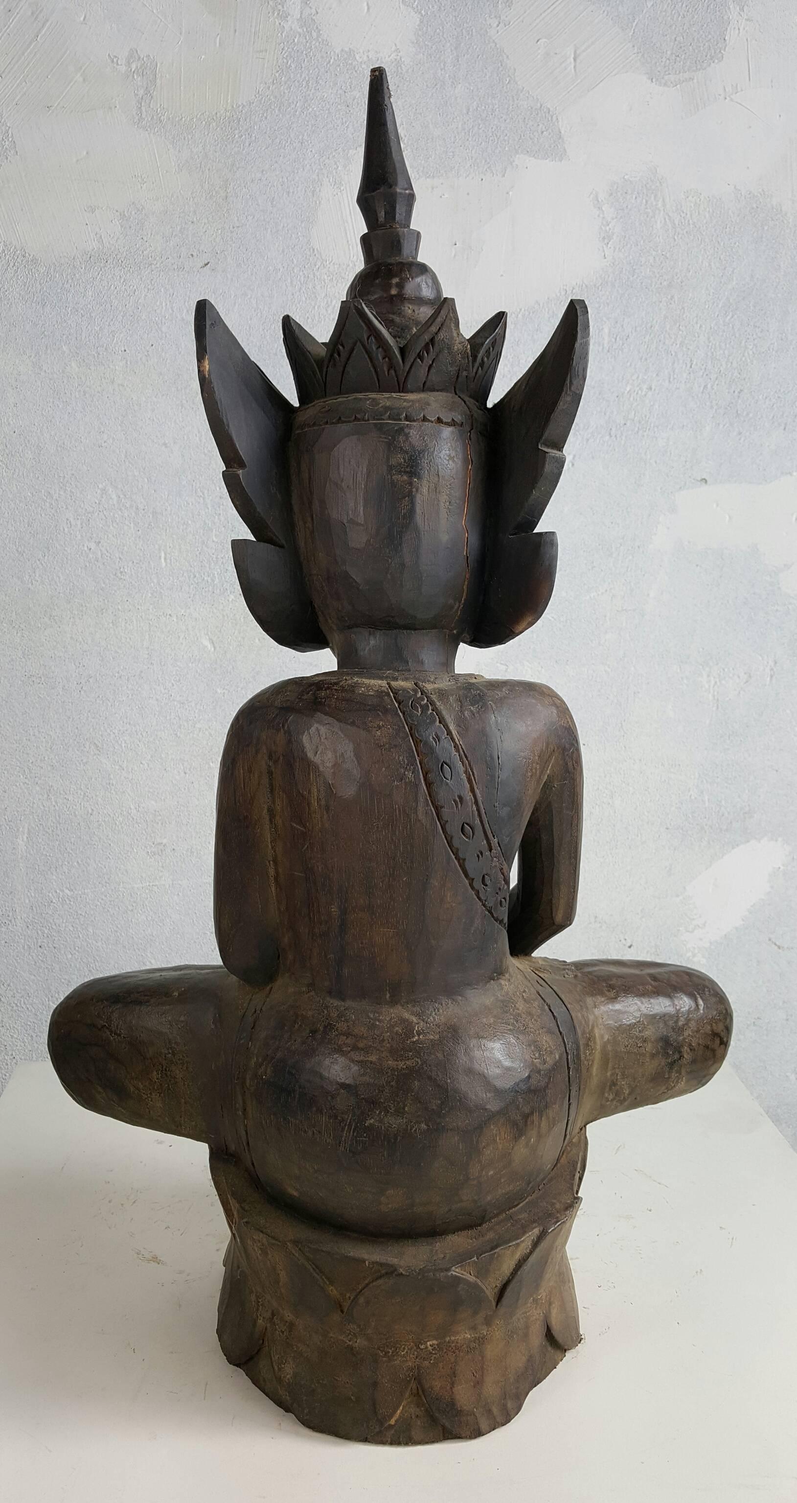 Exceptionally large Burmese carved wood statue of a Buddha on a raised pedestal base. The figure depicted seated in the attitude of 