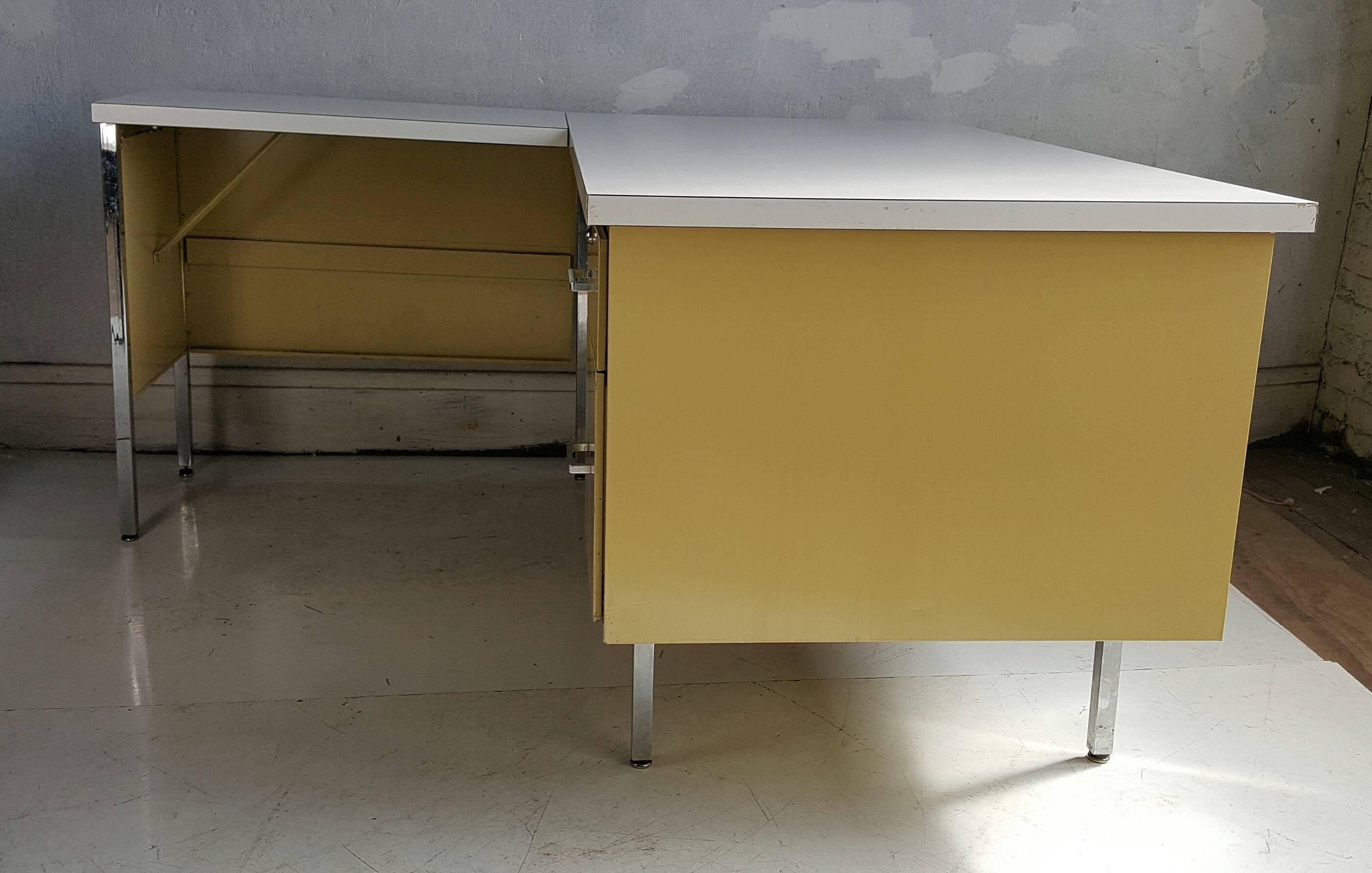 Mid Century Modern metal L-shape desk, made by Designcraft, Classic 1960s Yellow-green color. Retains original white laminate top. Generous top drawer as well as file drawer.