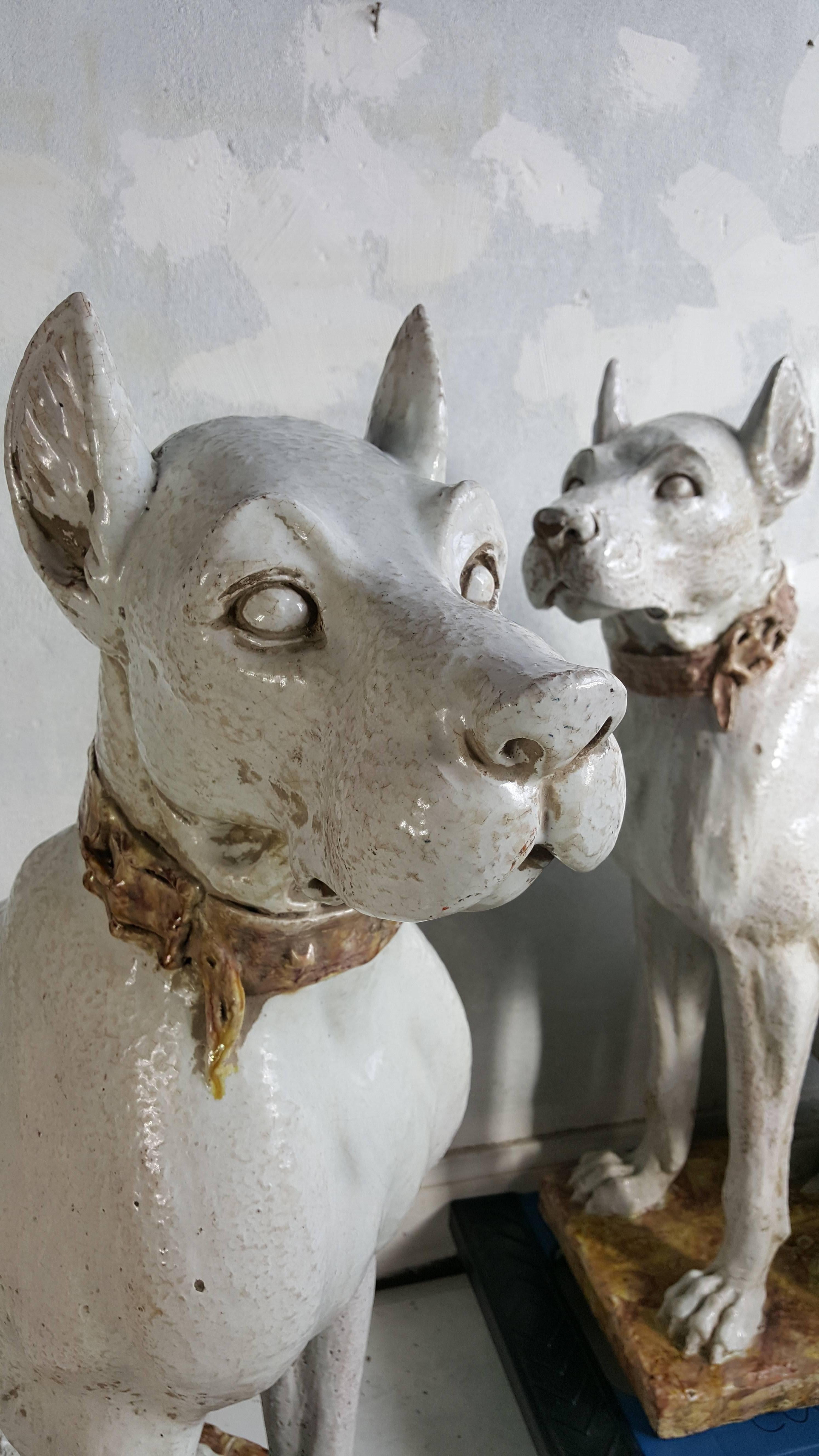 A pair of monumental 20th century glazed terra cotta dog sculptures. Exceptional quality, made in Italy, circa 1930s.
