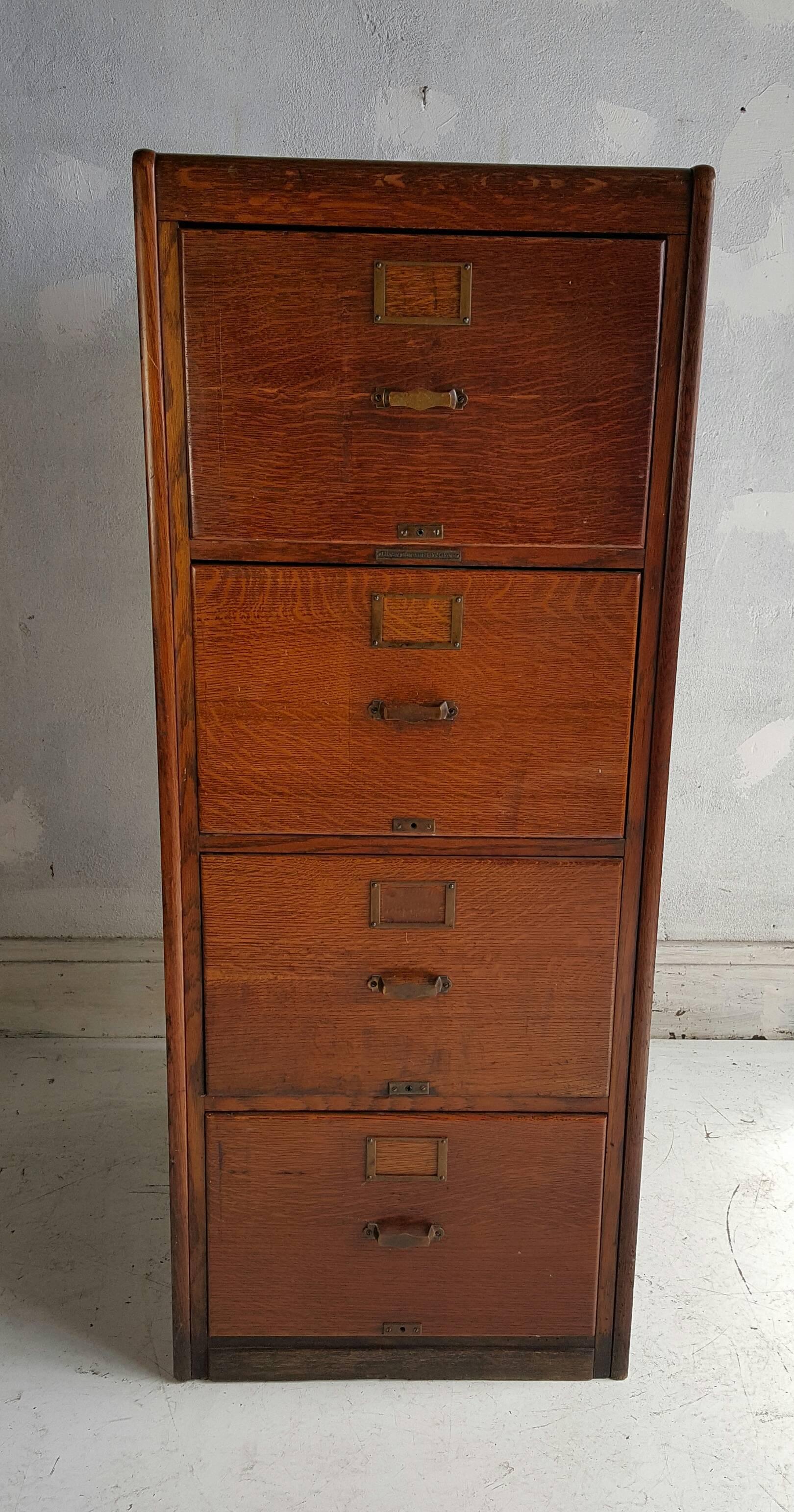 Classic quartersawn oak four-drawer file cabinet, finished raised panel sides and back, Wonderful warm patina, deep. generous storage.