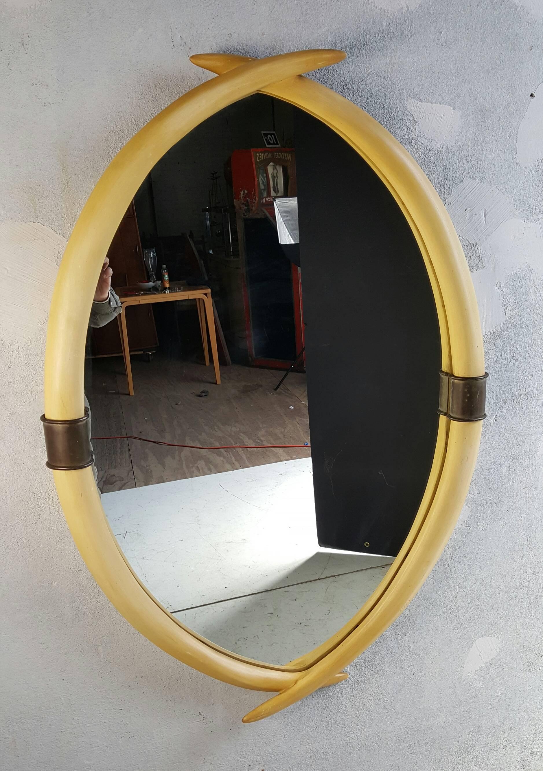 Hollywood Regency Brass and Faux Ivory Tusk Wall Mirror by Chapman, 1976   In Good Condition In Buffalo, NY