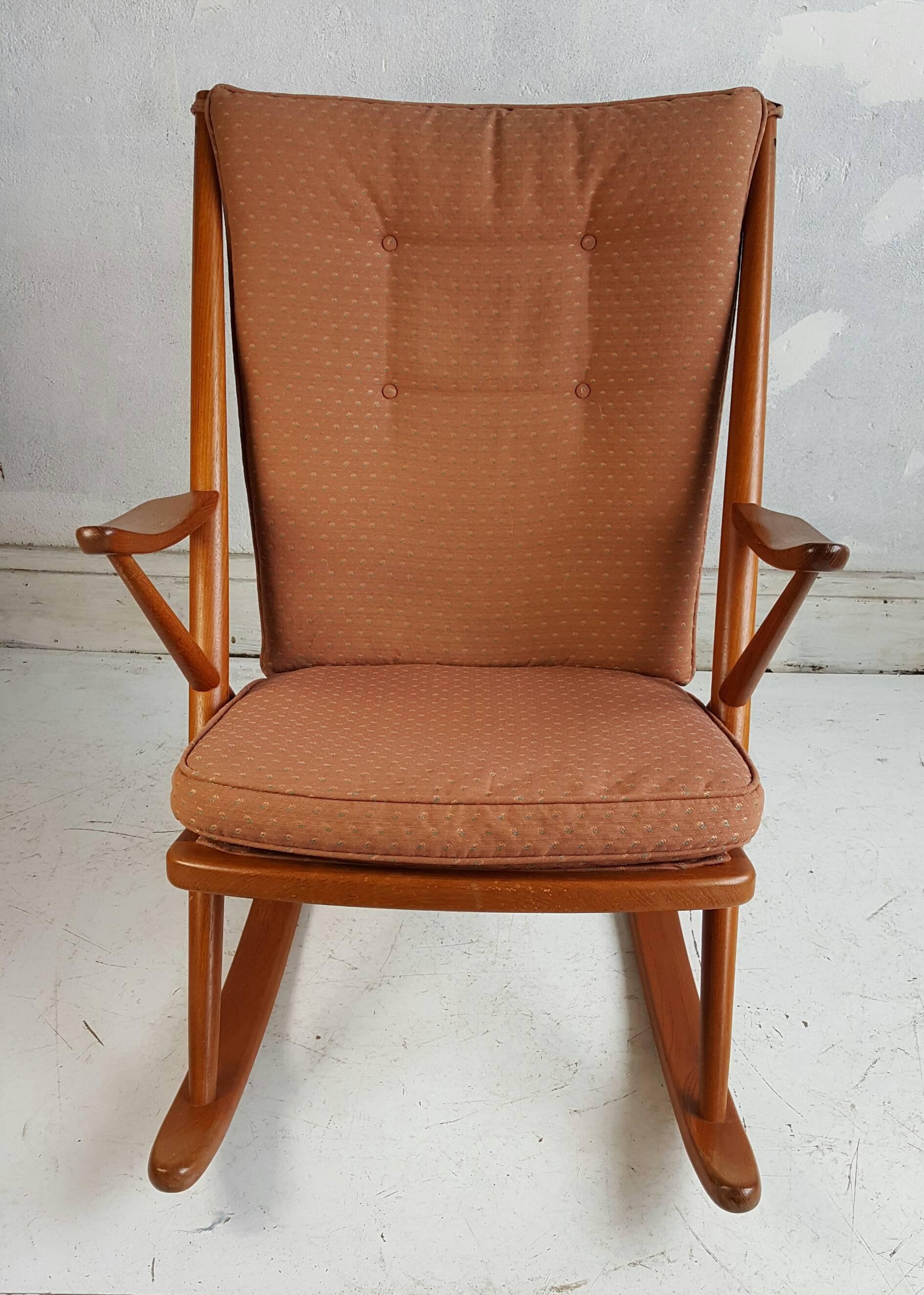 Danish modern Mid-Century rocking chair. Crafted in teak and designed by Frank Reenskaug for Bramin, Recently recovered, teak frame is in excellent vintage condition with typical wear for its vintage.