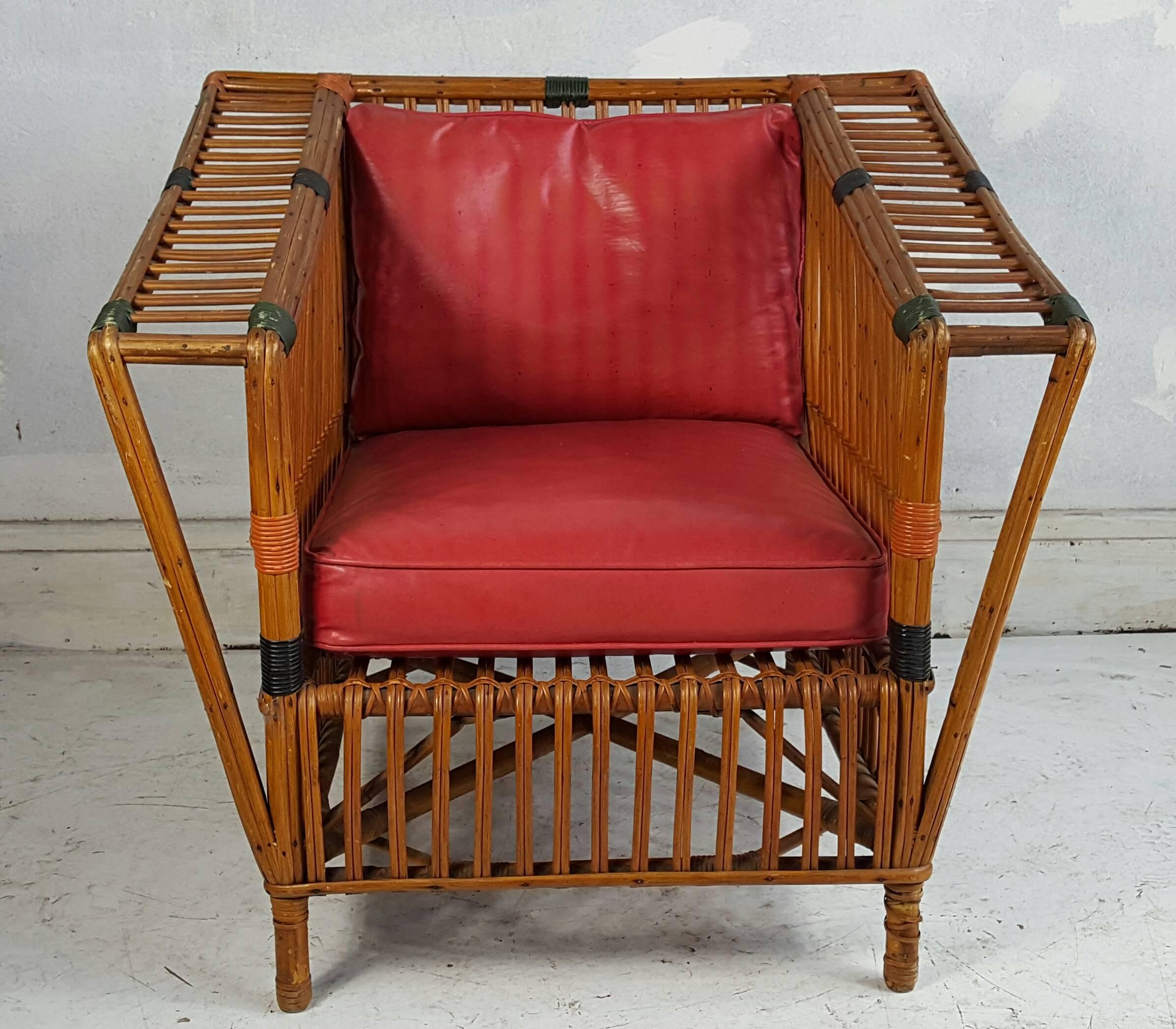 Unusual Art Deco Stick Wicker, split reed armchair, stream-line modern. Classic example, retains original finish, green and orange patinated paint. Extremely comfortable.