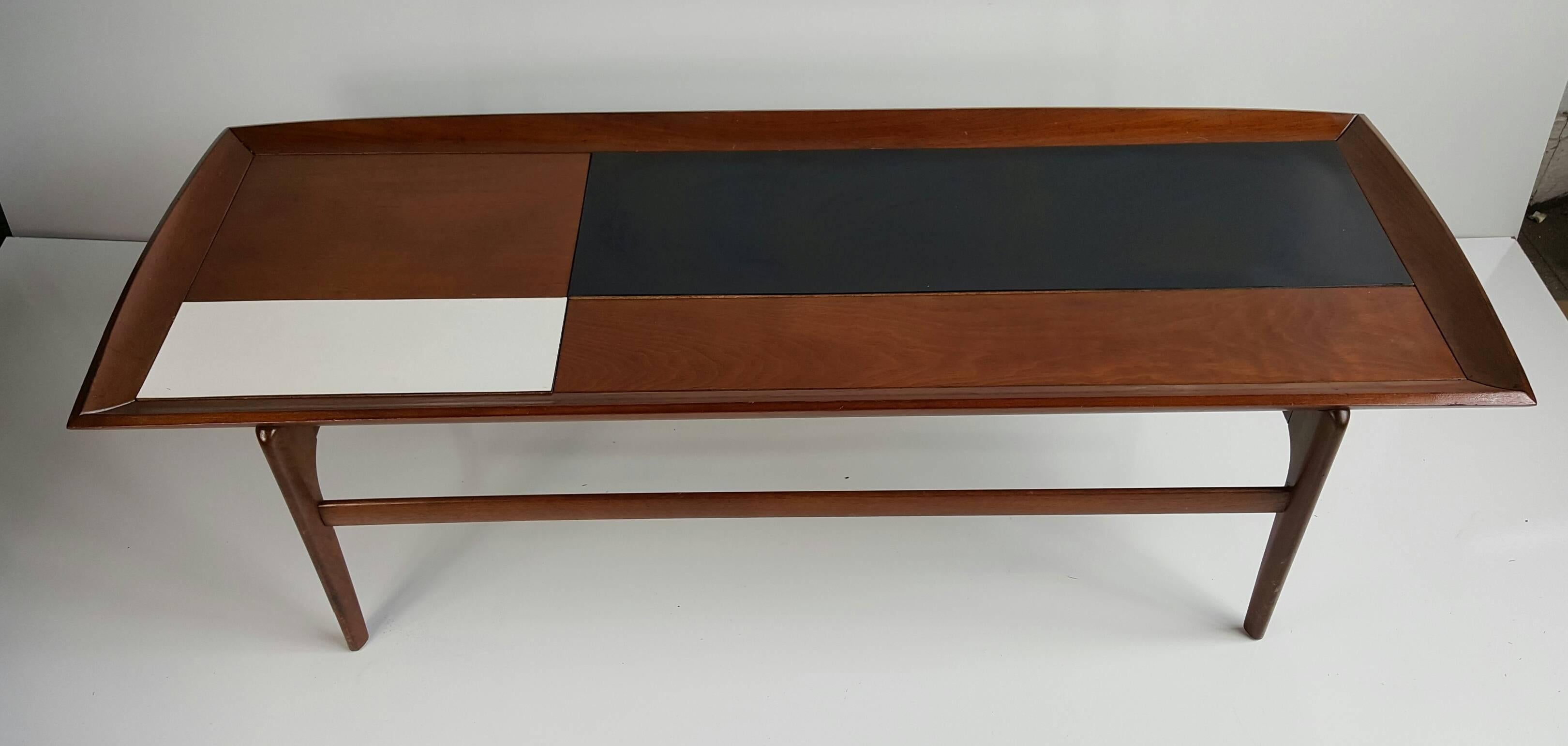 Handsome Mid-Century Modern coffee/cocktail table. Solid walnut top interesting black and white laminate inserts, raised edge.
