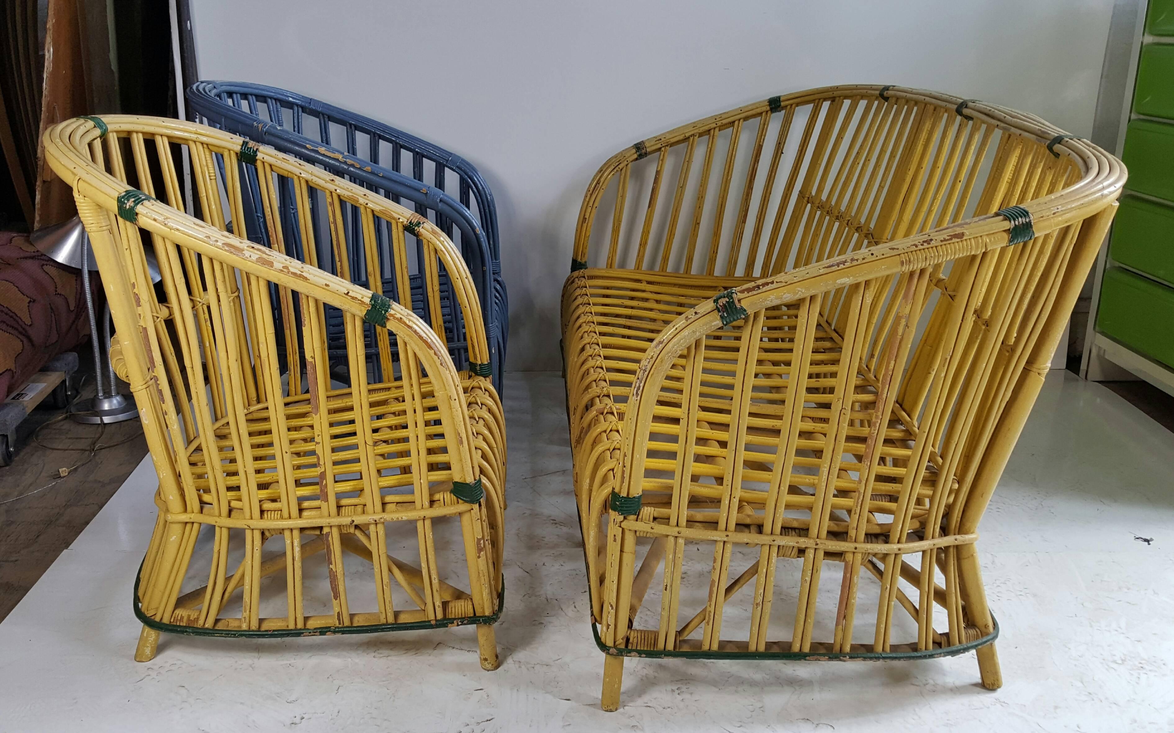 Three-piece Art Deco stick wicker / split reed. Set consists of three-seat sofa and two matching club chairs, wonderful design, yellow sofa and chair appear to be original paint, one matching chair re-painted in blue.