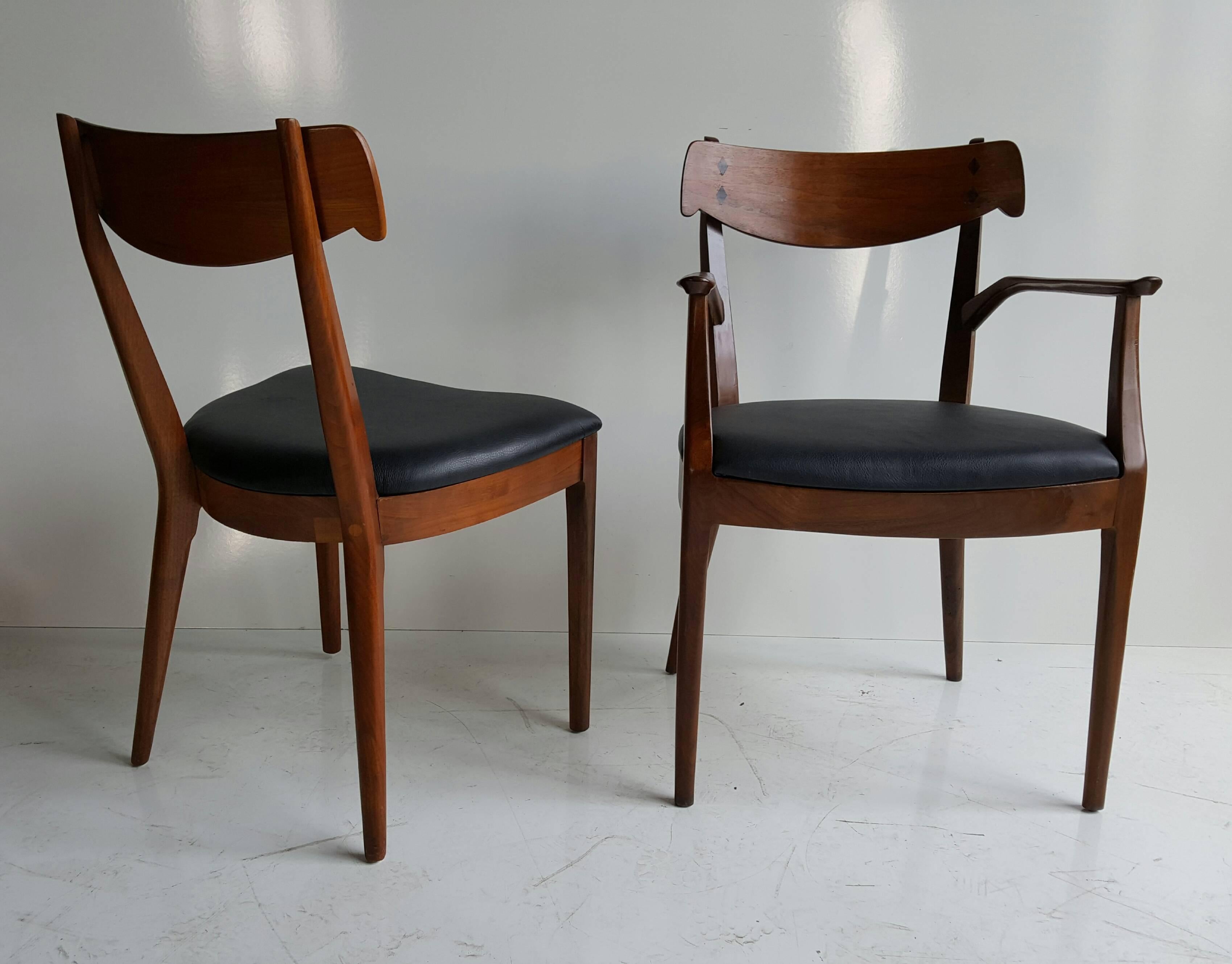 Finely sculpted set of ten walnut and rosewood inlaid dining chairs designed by Kipp Stewart and Stuart MacDougall for Drexel, circa 1950. Six newly upholstered in leather, four side chairs retain original Naugahyde.