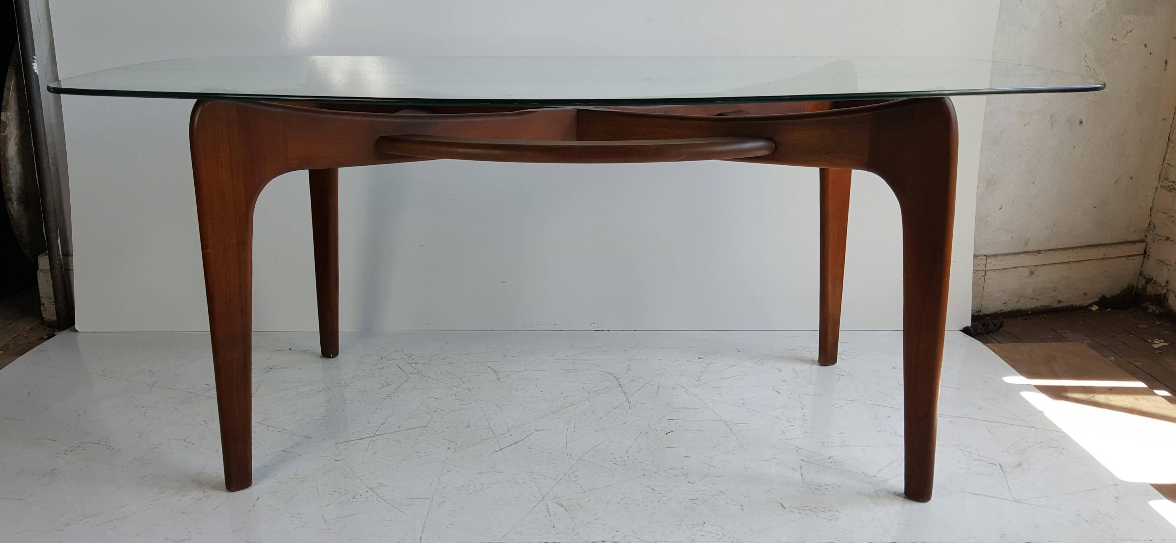 Boat-shaped glass topped dining table with Pearsall's sculptural walnut base as support by his company Craft Associates model 2179-T, Classic Mid-Century Modern design.
