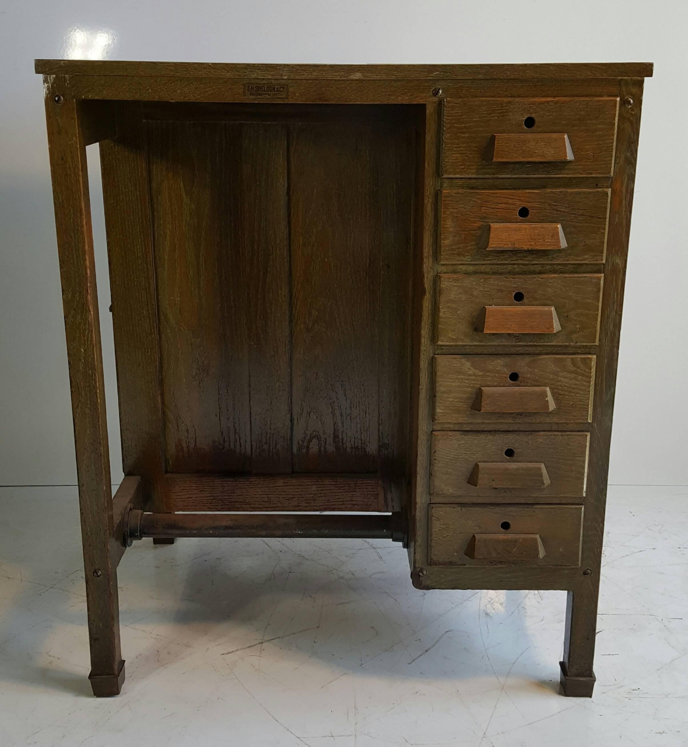 Cursed oak postman's / jeweler's Industrial desk, aniline green, wonderful patina, design and proportion. Six drawers, dove tail joinery, also retains cabinet door and cubby, circa 1920s.