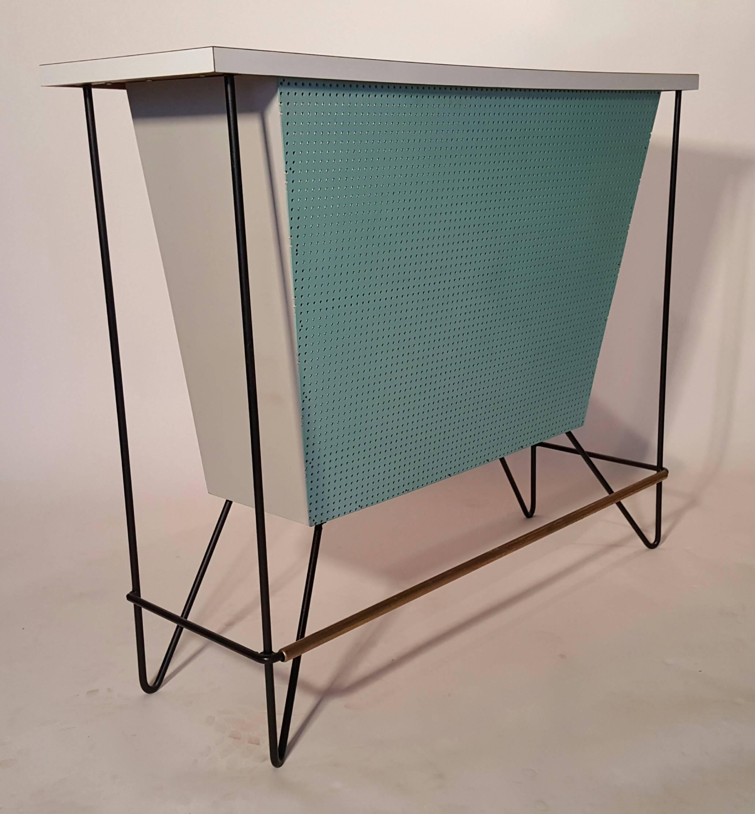 One of the lesser seen versions.. Classic Frederick Weinberg free-standing dry bar and two matching stools.. Bar retains all original finish.. white laminate top.. Perforated turquoise wood panel front, brass and iron.. Original wire iron bar