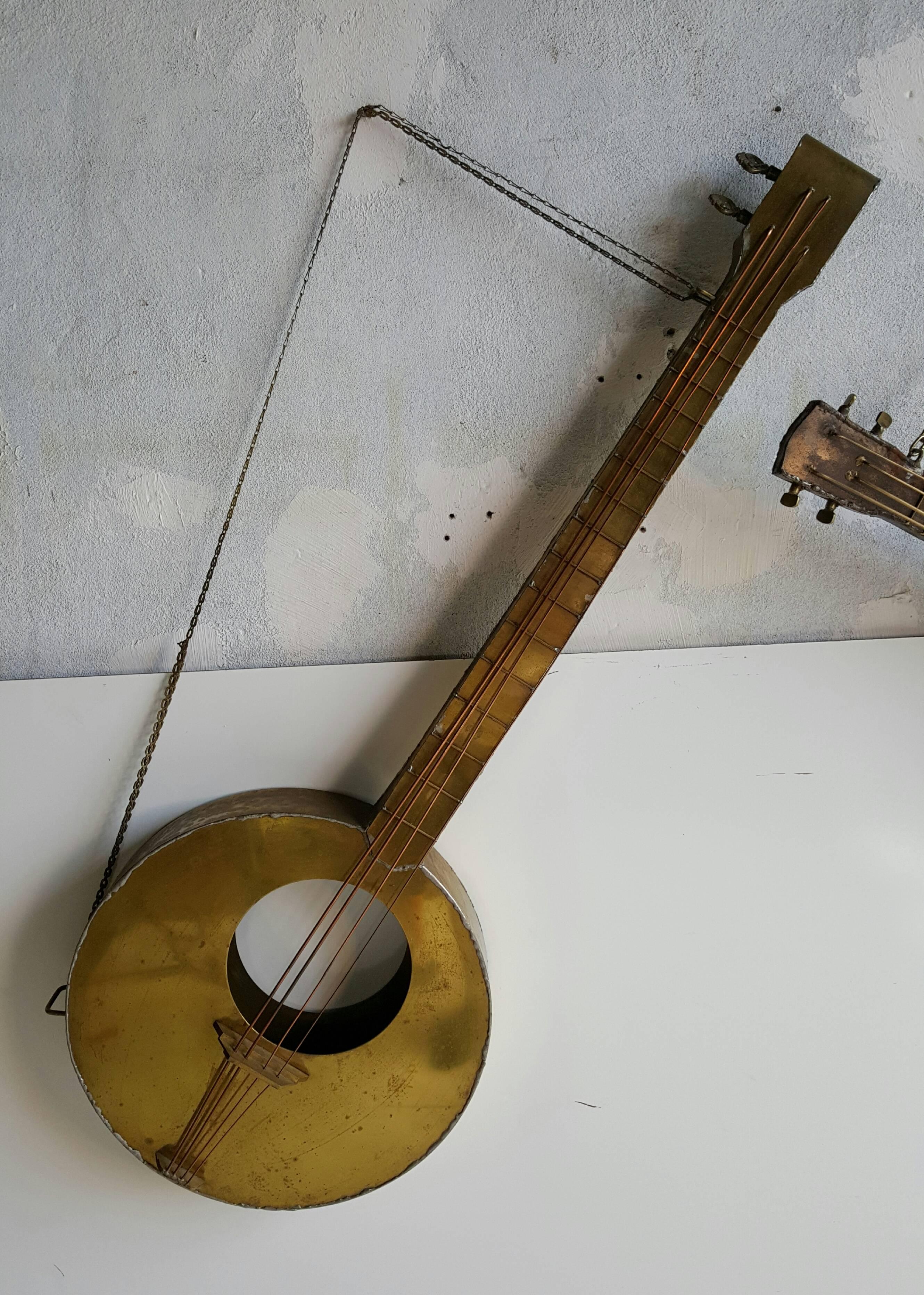 Modernist Folk Art metal musical instrument sculptures, depicting 'Picasso-like guitars,, Very well executed, hand welded, wonderful form and patina, large guitar or banjo measures 45