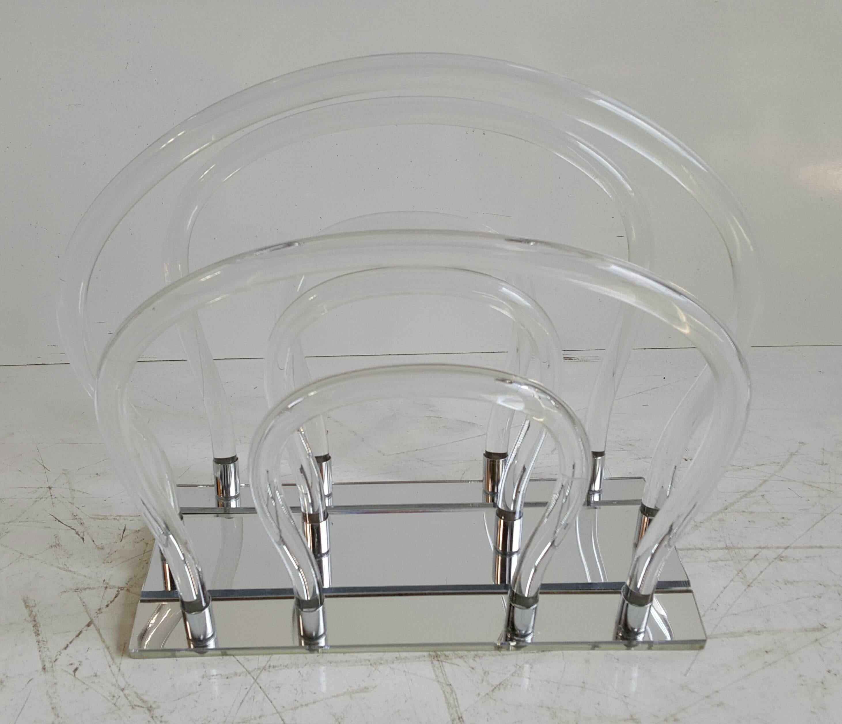 Very unique Lucite magazine holder by Dorothy Thorpe. Six bent Lucite tubes and chrome base. Excellent original condition.