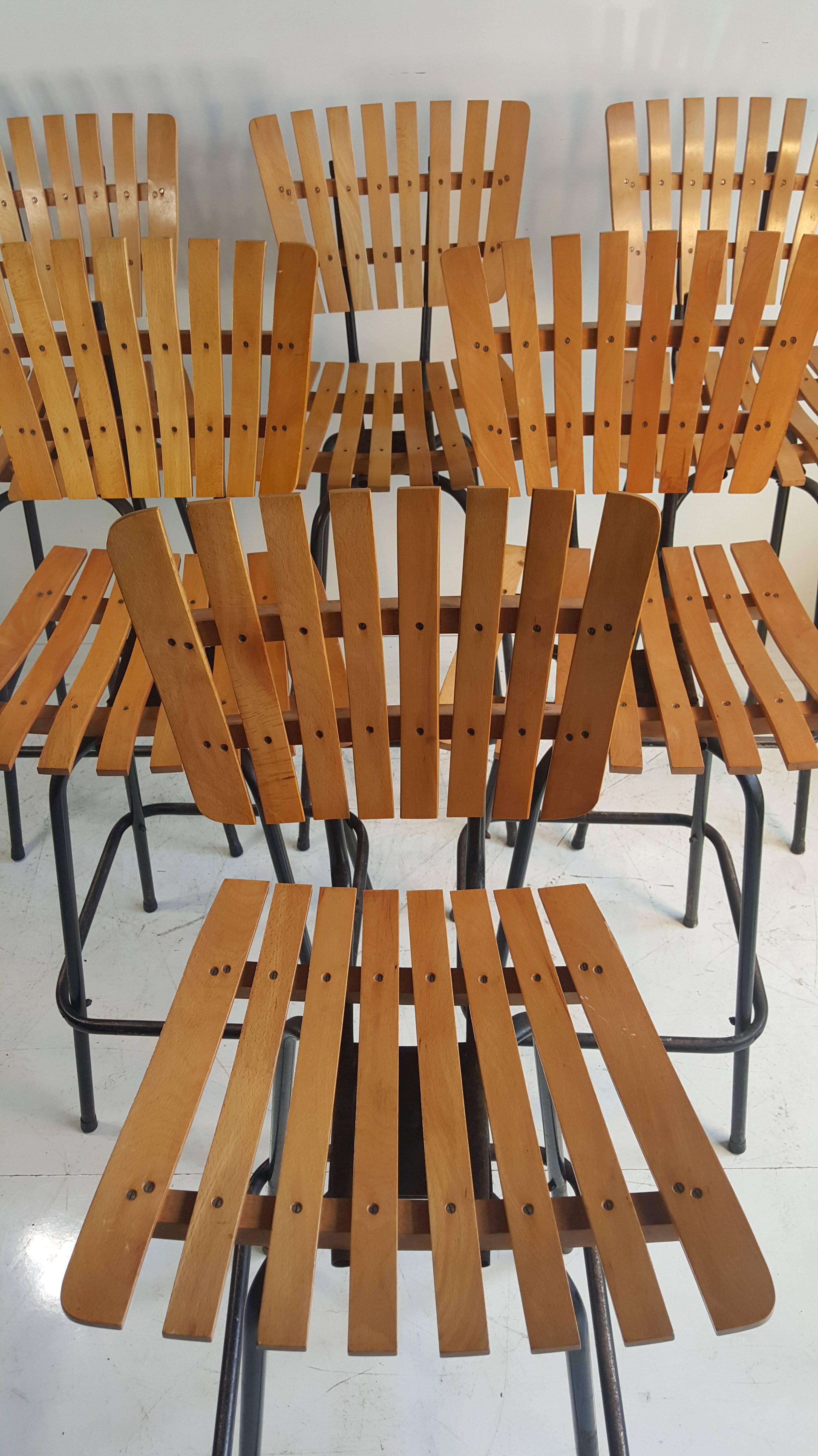 Set of six matching bar stools designed by Arthur Umanoff, Classic Mid-Century Modern, slatted wood seats and backs, tubular iron bases, smooth swivel.