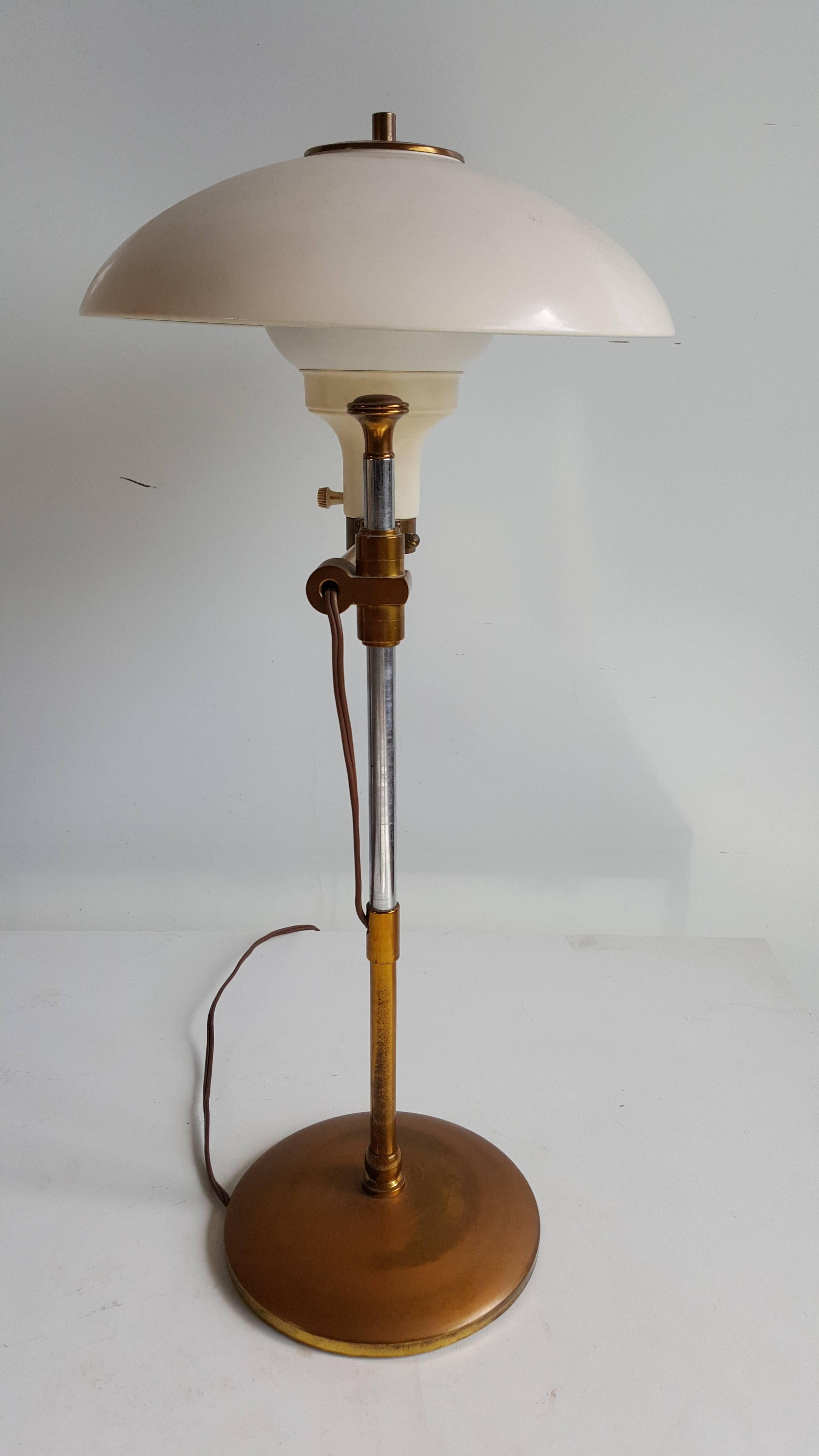 Wonderful desk lamp by Paavo Tynell for Taito, Finland, with large dome crème colored enameled shade, exquisite modernist Bauhaus design, superior quality. Brass detailing, base, finial and fittings.