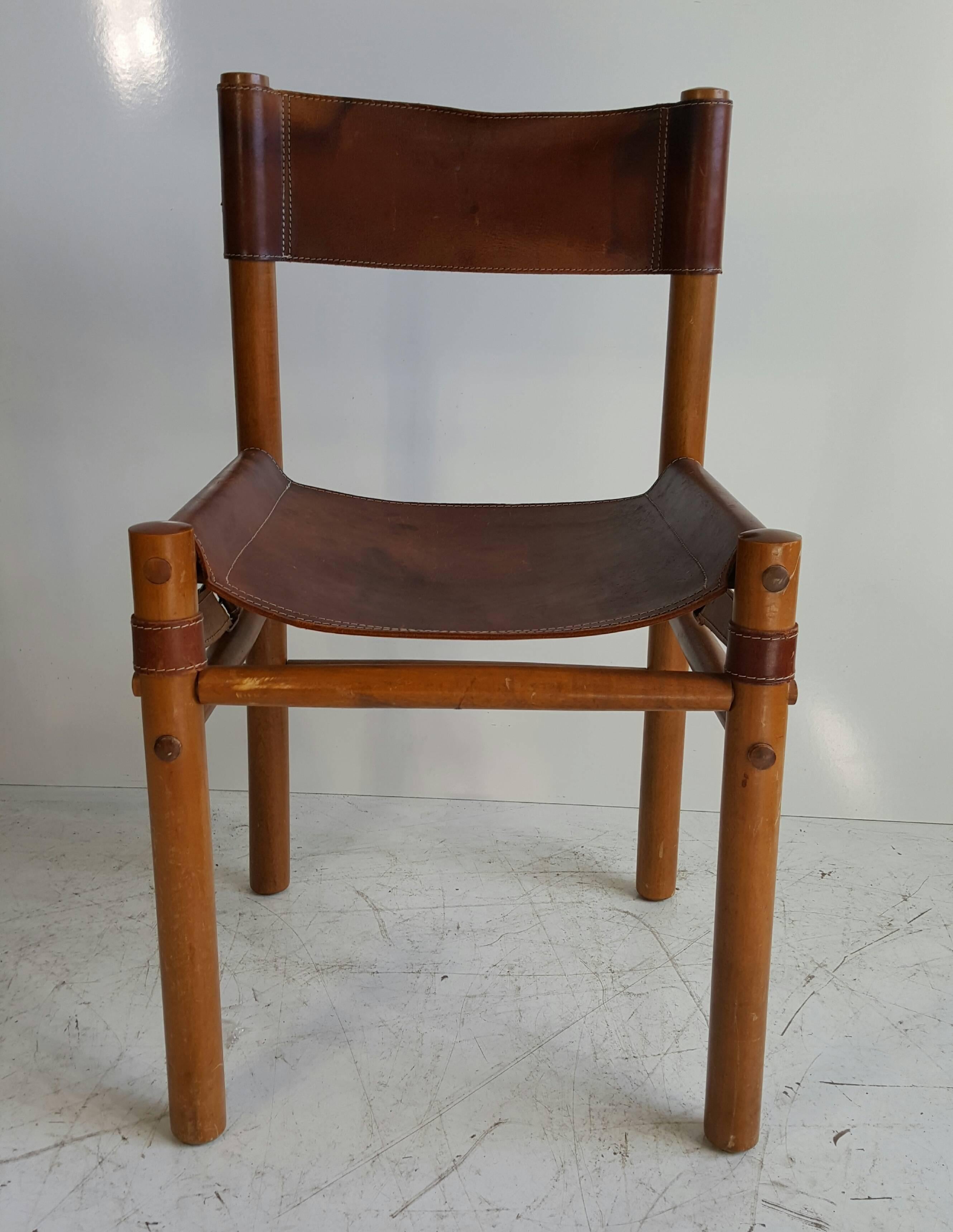 Arne Norell leather safari side chair. Made in Denmark. Retains original brown leather sling seat and back. Extremely comfortable.