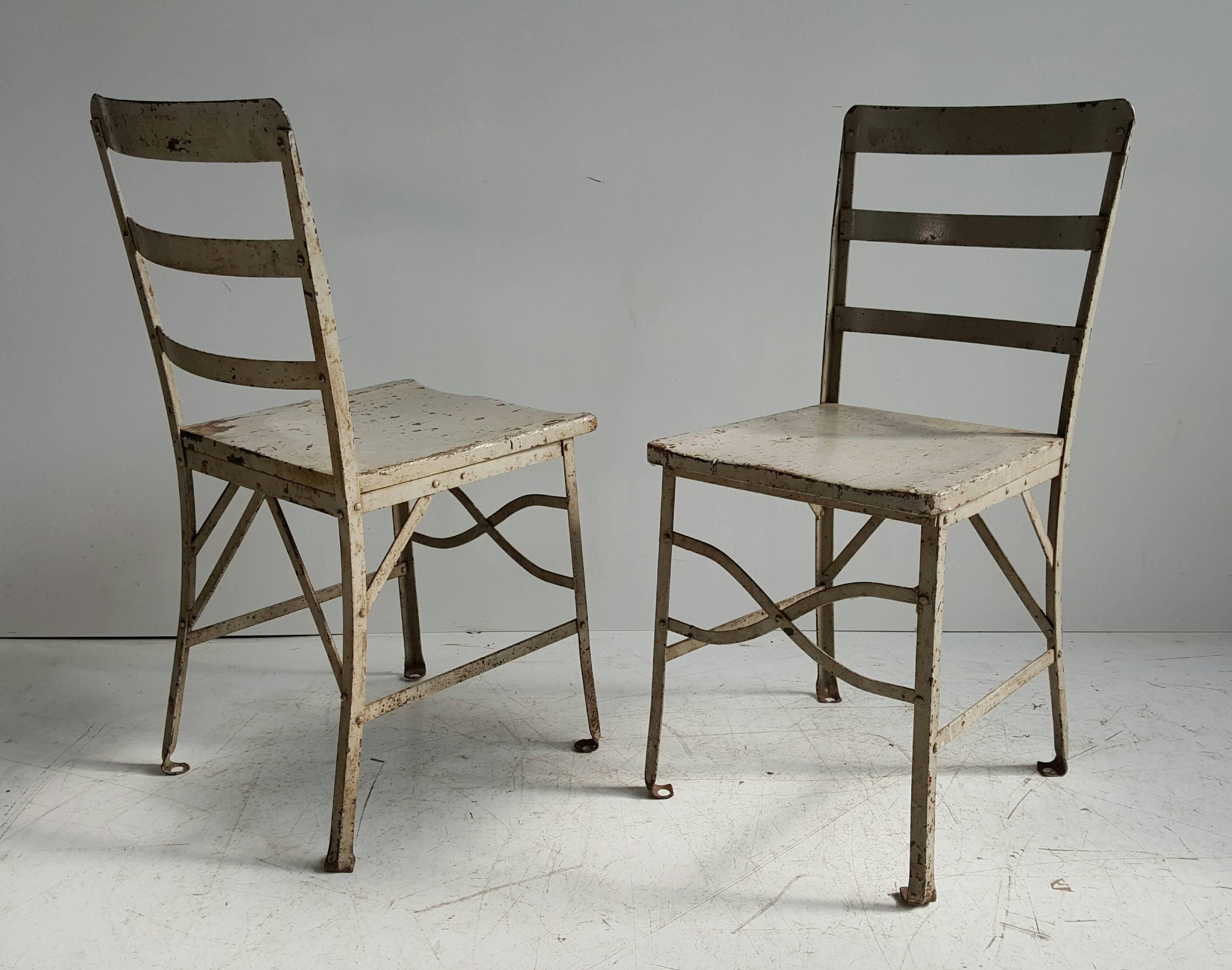 Pair of American modernist industrial chairs, old factory grey paint, attributed to Toledo metal furniture co., one of the lesser seen versions, wonderful finish, patina, charming pair, amazing quality and construction, heavy.