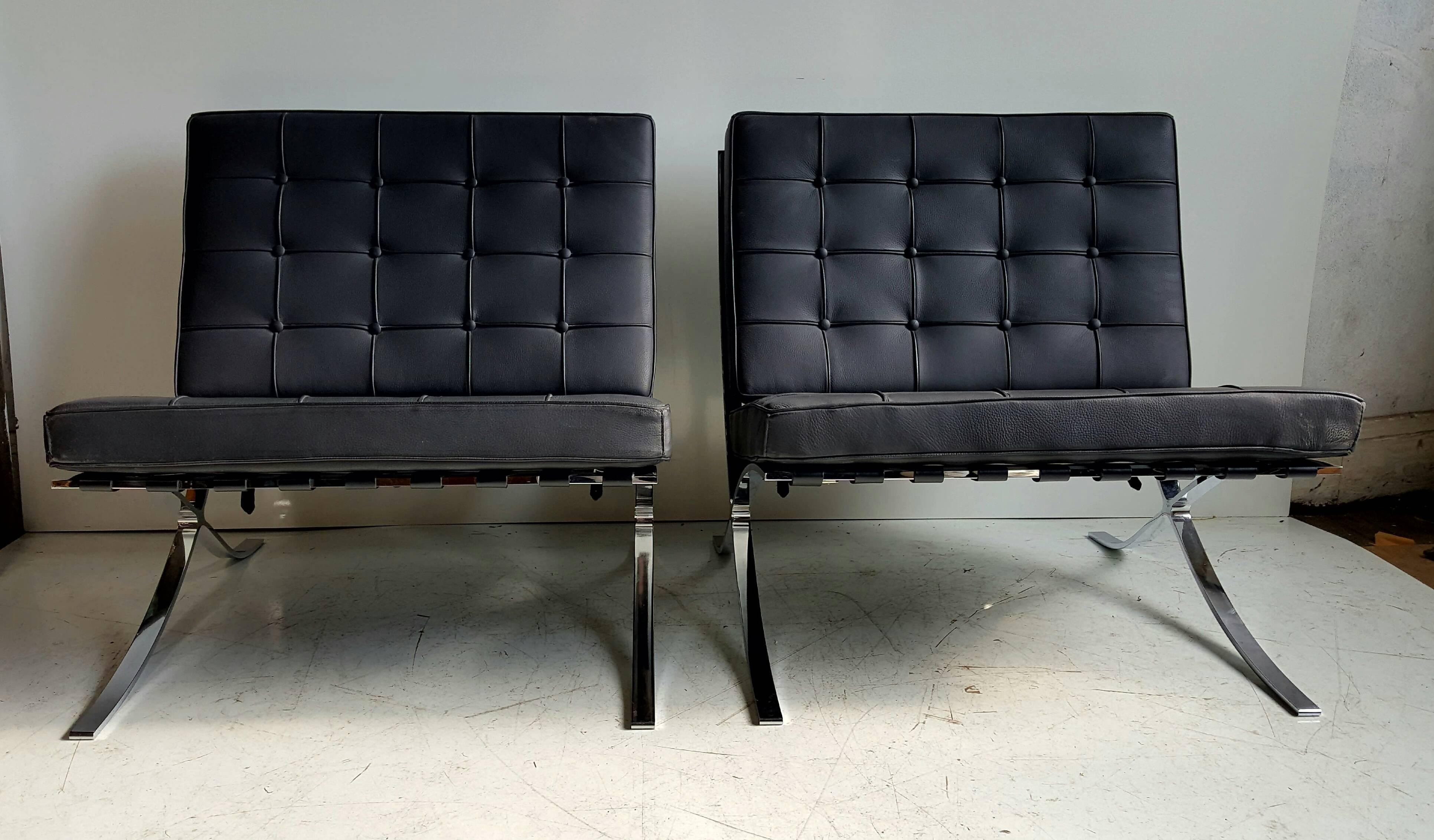 Classic pair Modernist Barcelona chairs, designed by Mies van der Rohe, made in Italy. Superb quality, wonderful original condition. Black leather signed made in Italy to bottom side. Quality chrome frames in mint original condition.