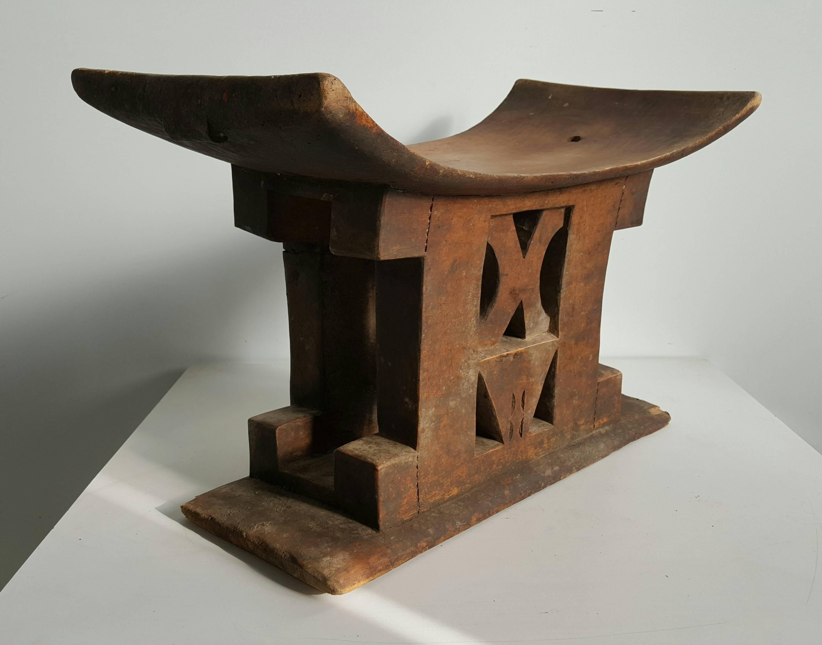 African Ashanti wood stool, Ghana, circa 1920s. Great design Art Deco. The Golden Stool (Ashanti-Twi: Sika 'dwa) is the royal and divine throne of the Ashanti people. According to legend, Okomfo Anokye, High Priest and one of the two chief founders