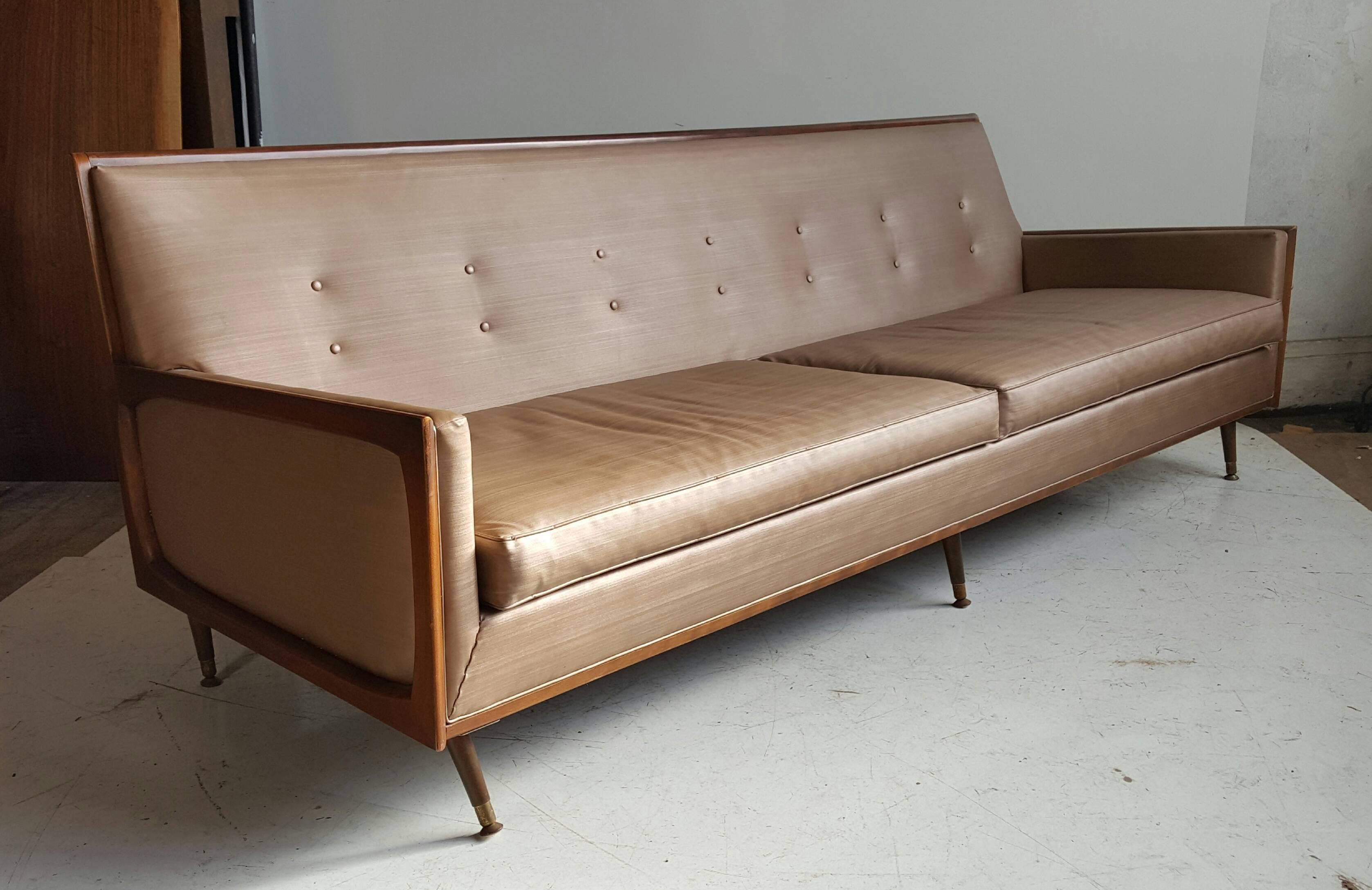 Sleek, elegant, Mid-Century Modern sofa, Classic styling, walnut frame. Retains original vinyl fabric upholstery in nice usable condition, would be fabulous reupholstered.