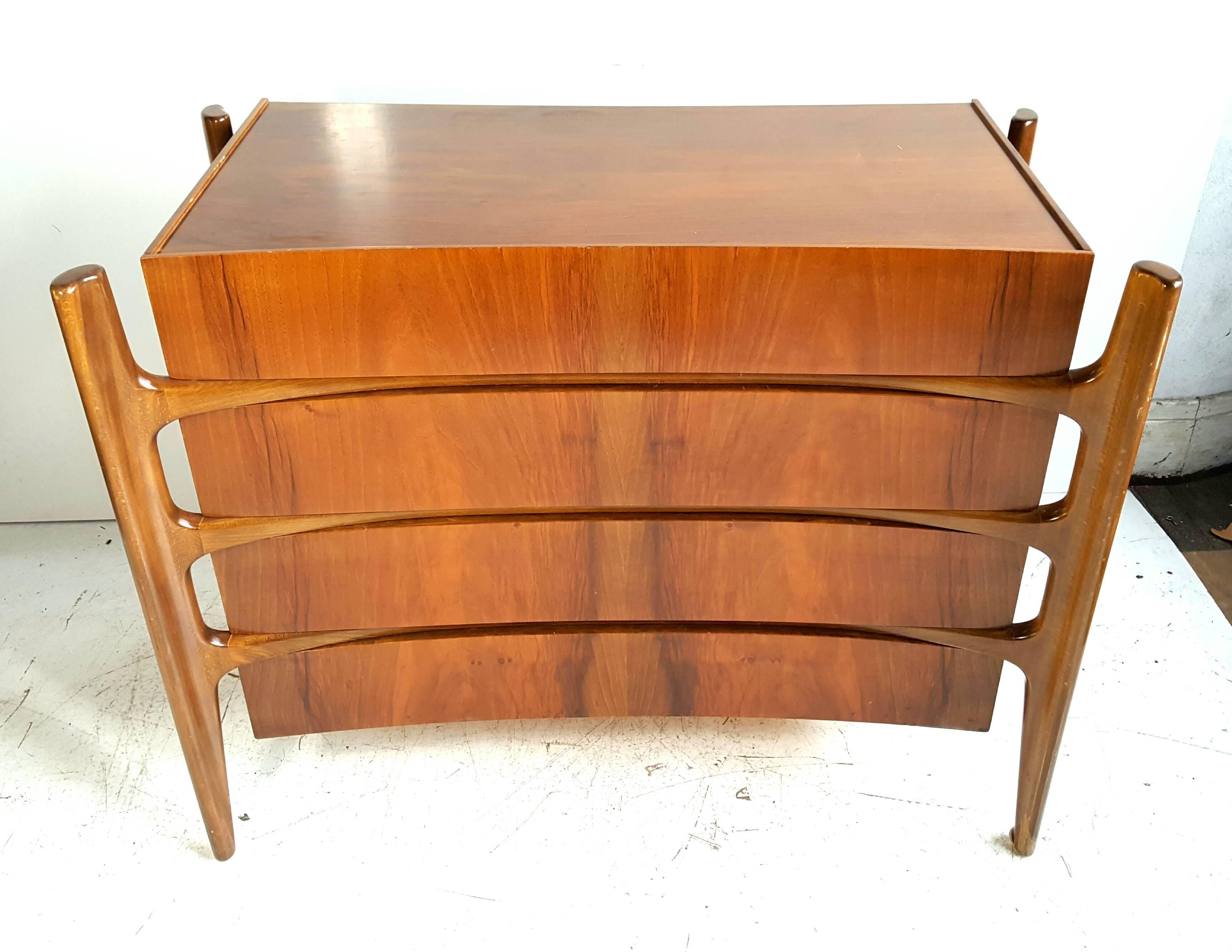 Four-drawer chest by William Hinn for Urban Furniture Sweden, 1950s.

Beautiful curved chest or dresser. This piece shows an exquisite organic and amorphic design. The wooden frame reminds of a skeleton, the large set of drawers completes the