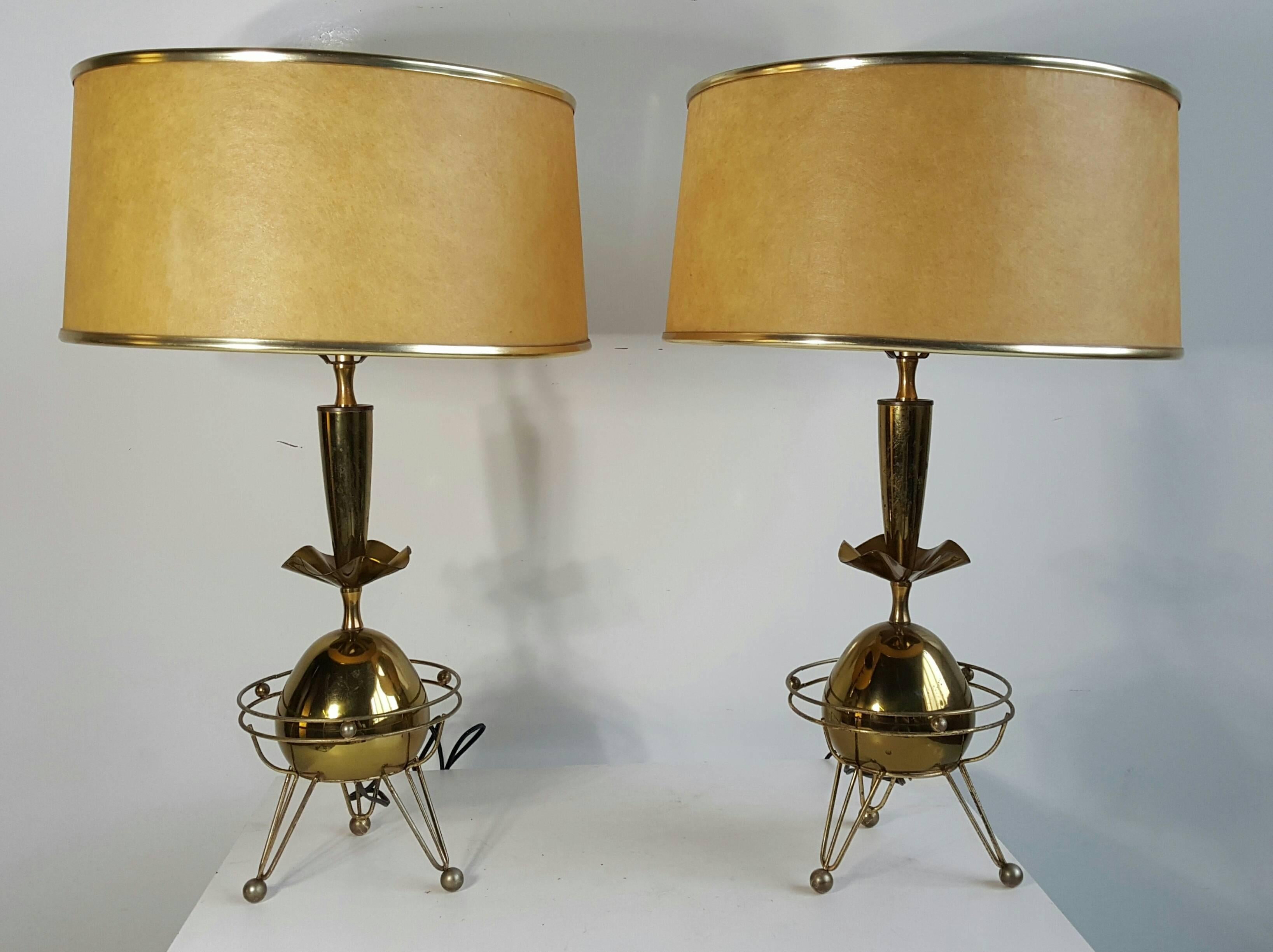 Classic pair of Mid-Century Modern brass atomic lamps,,Retain original parchment lamp shades measuring 15