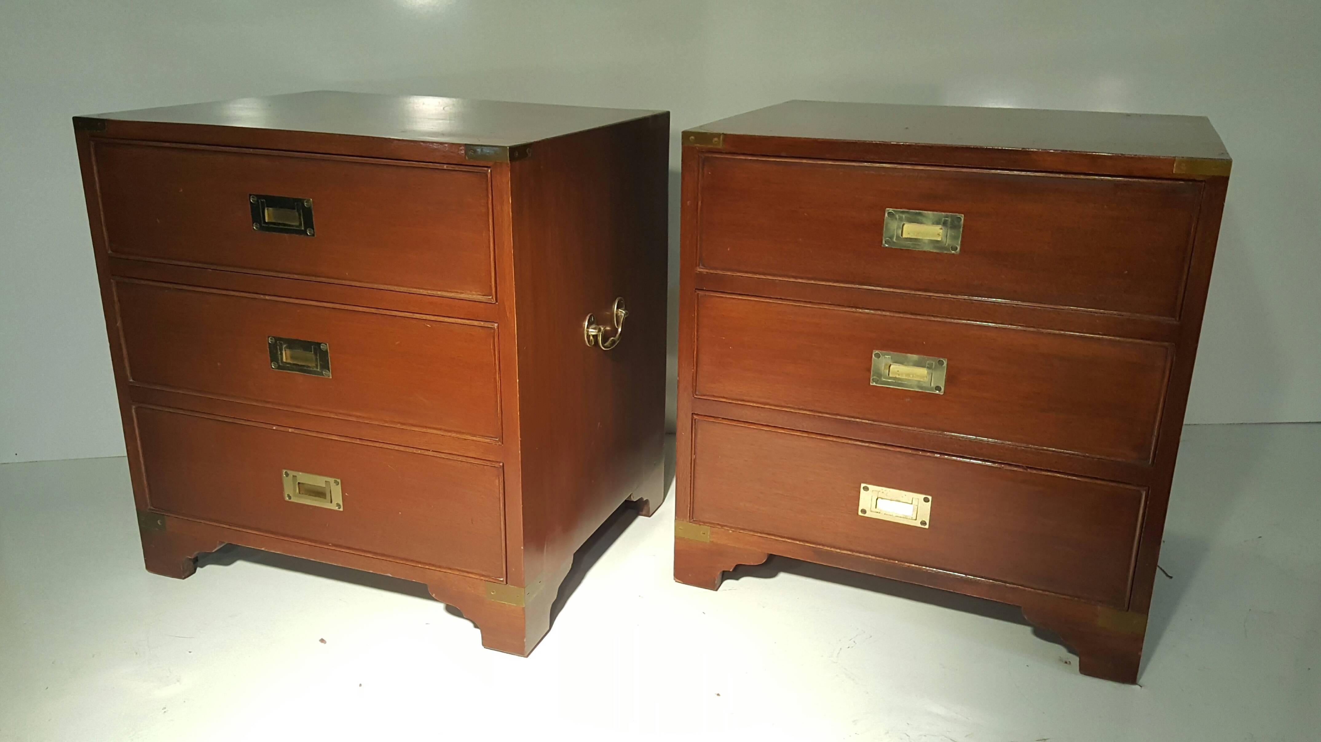 Classic pair of mahogany and brass Campaign stands/chest. Brass-mounted Campaign chest featuring three drawers with flush brass handles and larger handles on each side. This small chest of drawers or commode would make a great nightstand or bedside