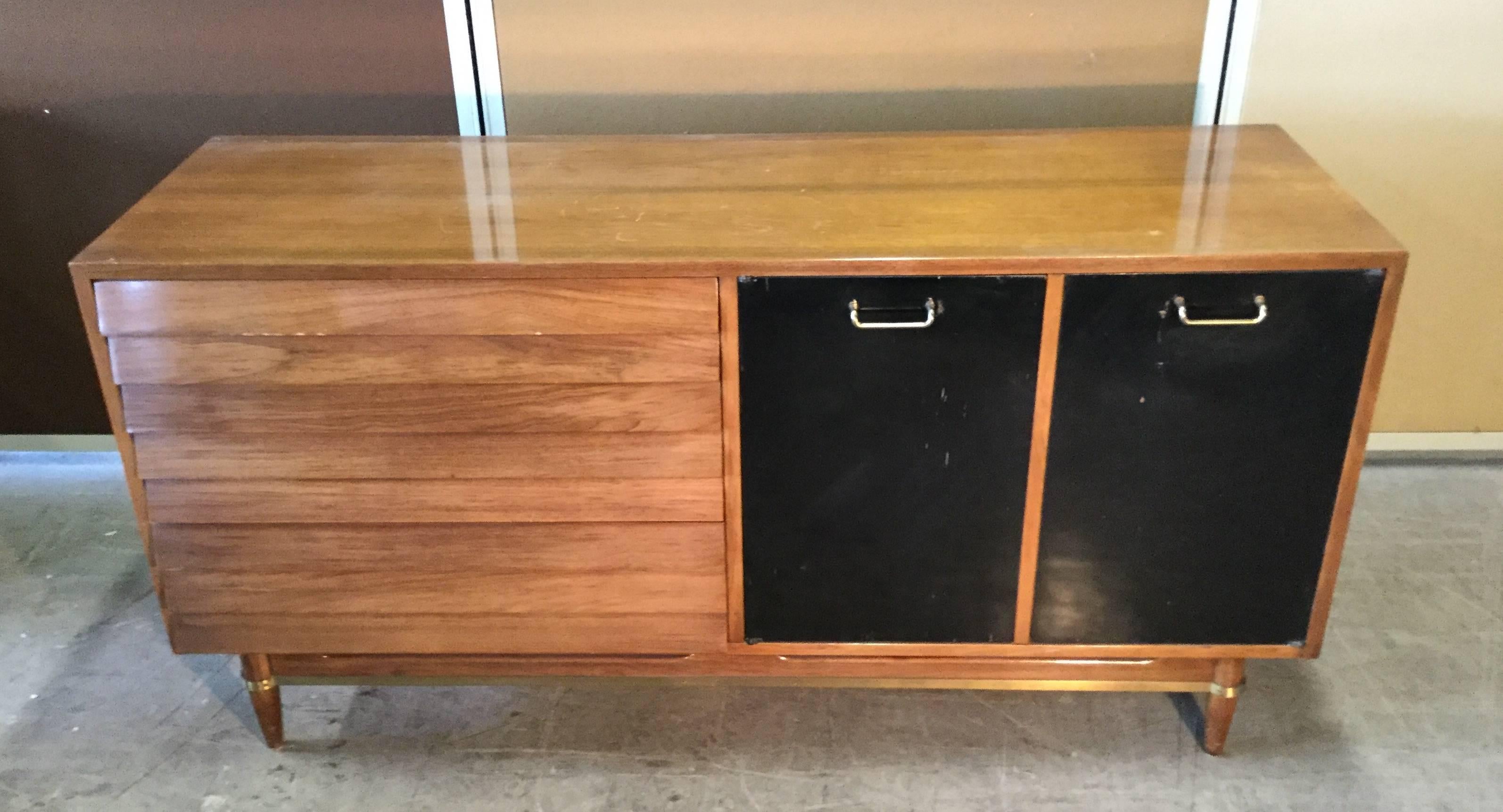 Classic Modernist walnut and brass server or credenza, American of Martinsville designed by Merton Gershun for his Dania collection. Credenza features walnut finish with louvered front drawers as well as two lacquered doors and drawers. Brass trim
