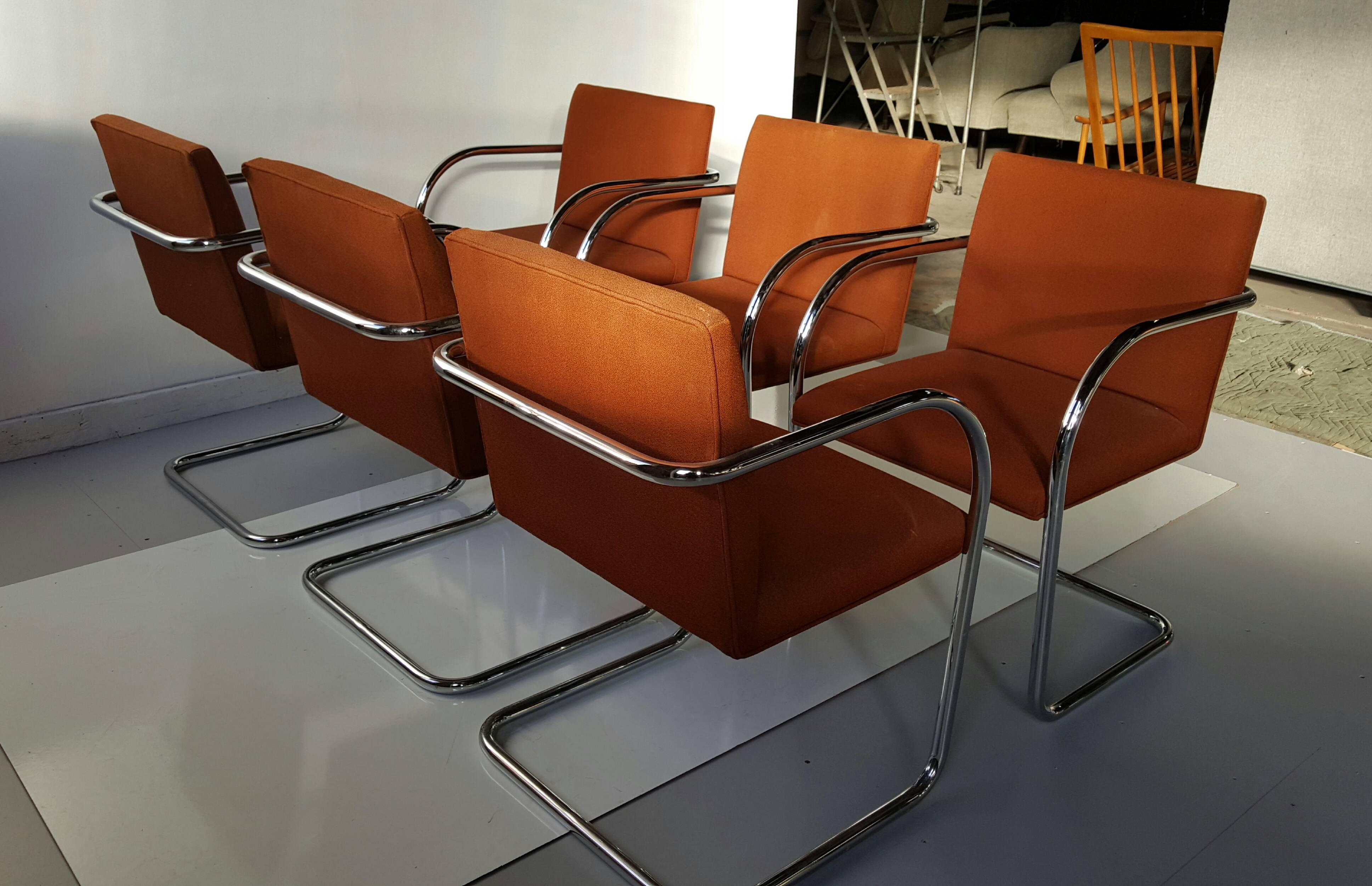 Classic set of 12 chromed steel armchairs. Brno, designed by Ludwig Mies van der Rohe and Lilly Reich, manufactured by Gordon International. Extremely comfortable. Suburb quality, retains original orange-brown wool fabric.

The Brno chair (model