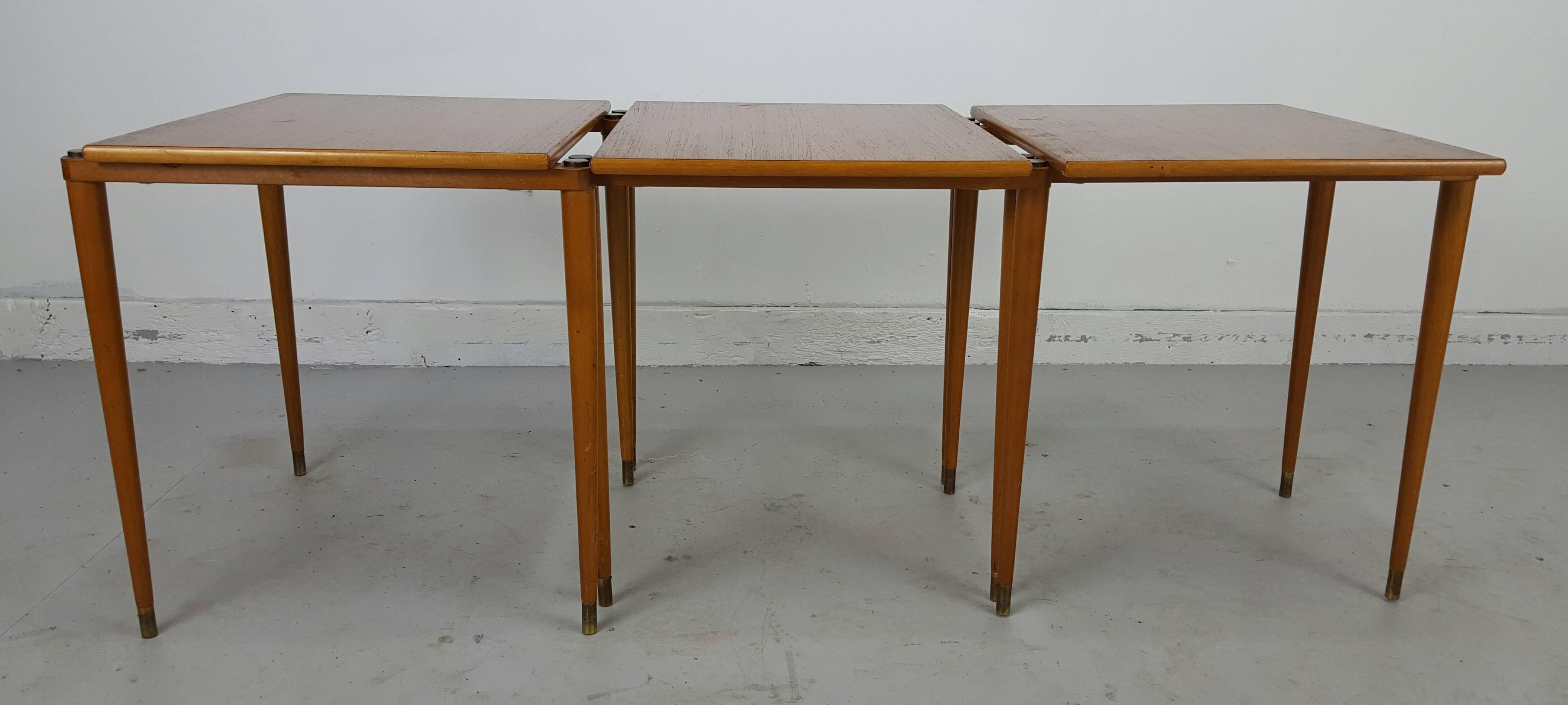 Danish stackable tables manner of Jens Quistgaard for Nissen. Classic modernist, pencil taper legs, nice brass button detail, measure 20