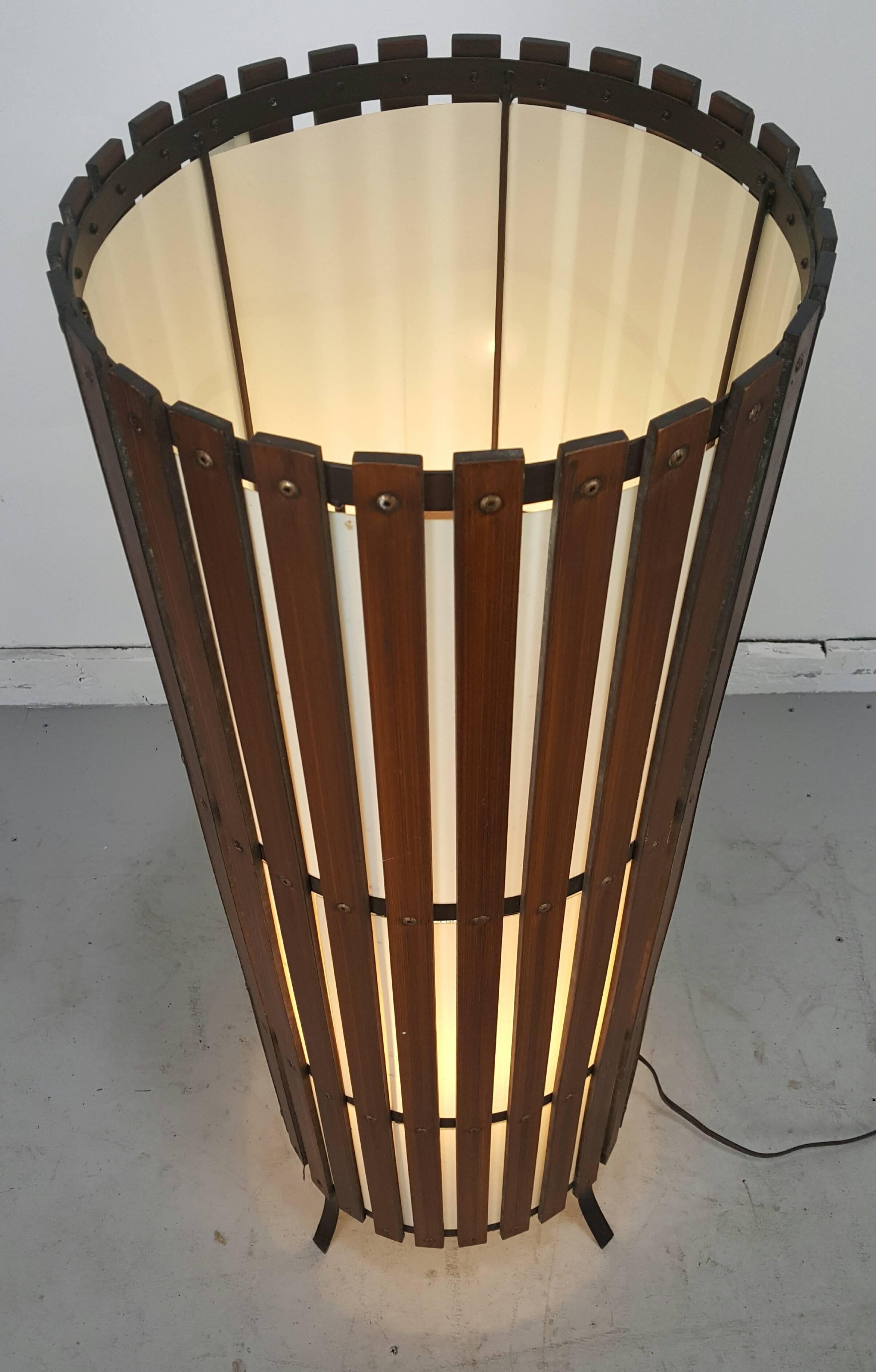 Contemporary modernist walnut slat wood cylinder floor lamp. Quality solid oiled walnut slats, retains original cylinder white acrylic shade, black metal fee. Wonderful warm glow when illuminated.