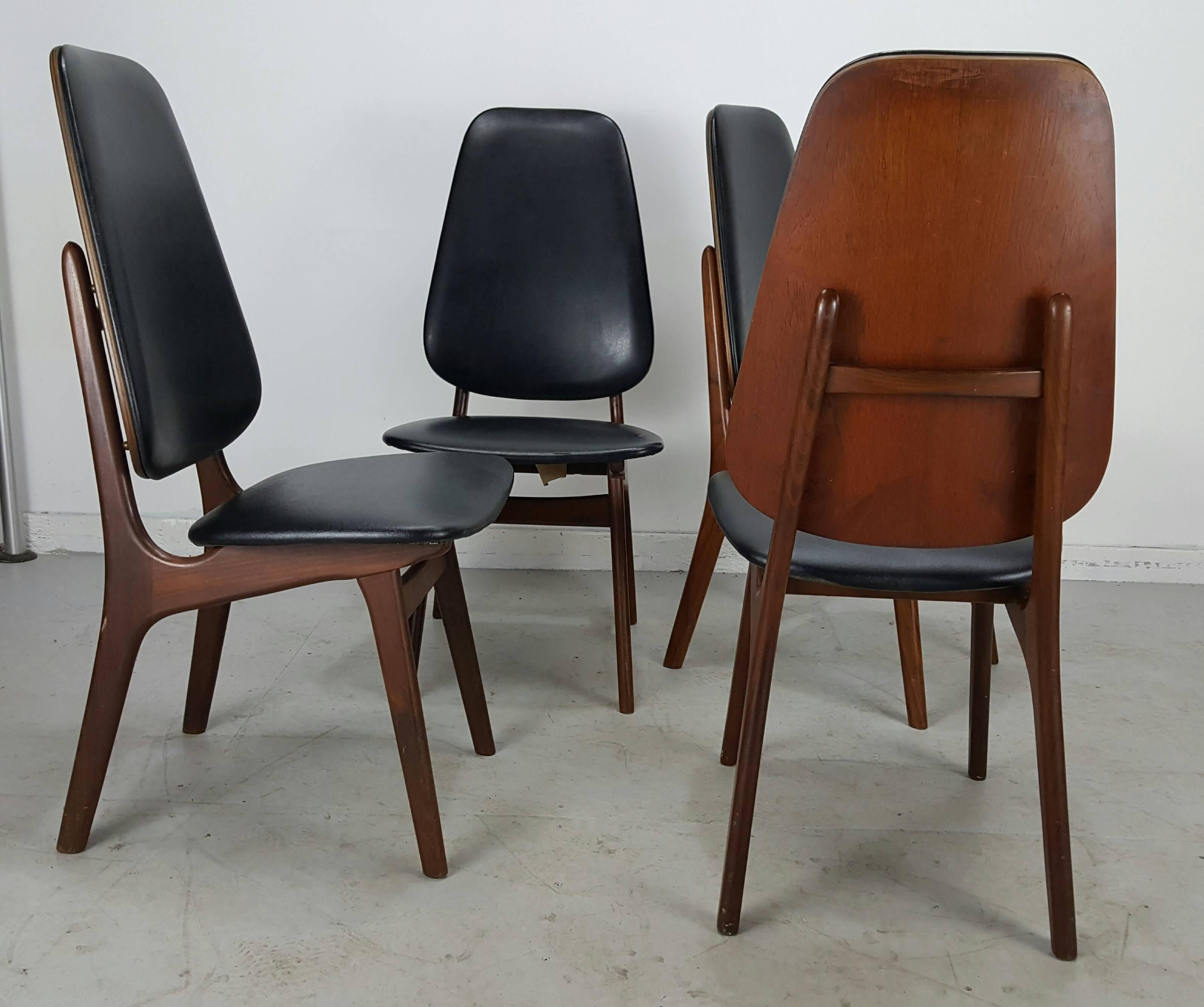 Set of four Kofoed Larsen High Back Dining Chairs, Denmark. Wonderful teak wood frames, retain original black naugahyde fabric, extremely comfortable, handsome profile, brass grommet detail, sculptural Kagan-esque design.